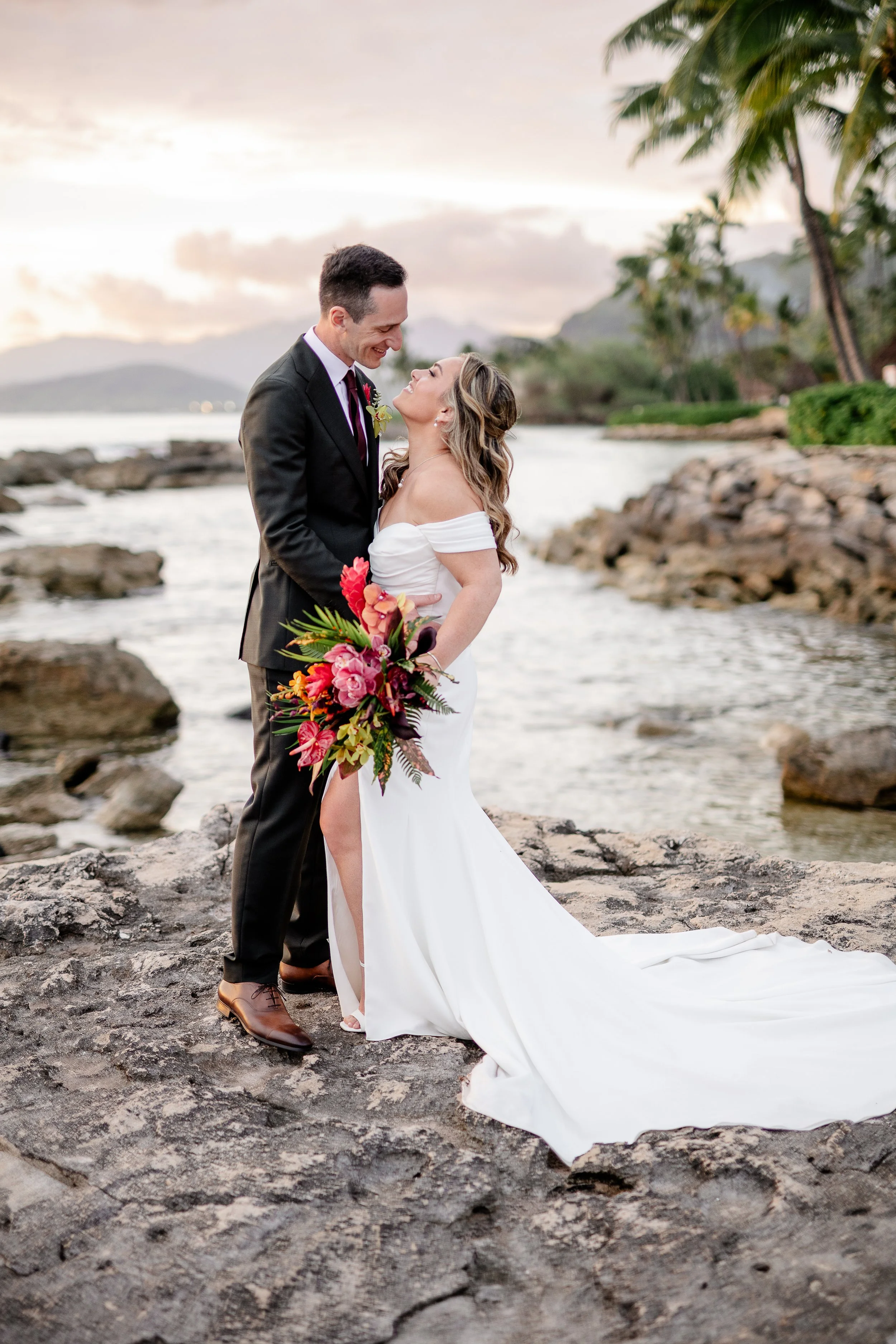 bride and groom on a beach in Hawai'i at sunset