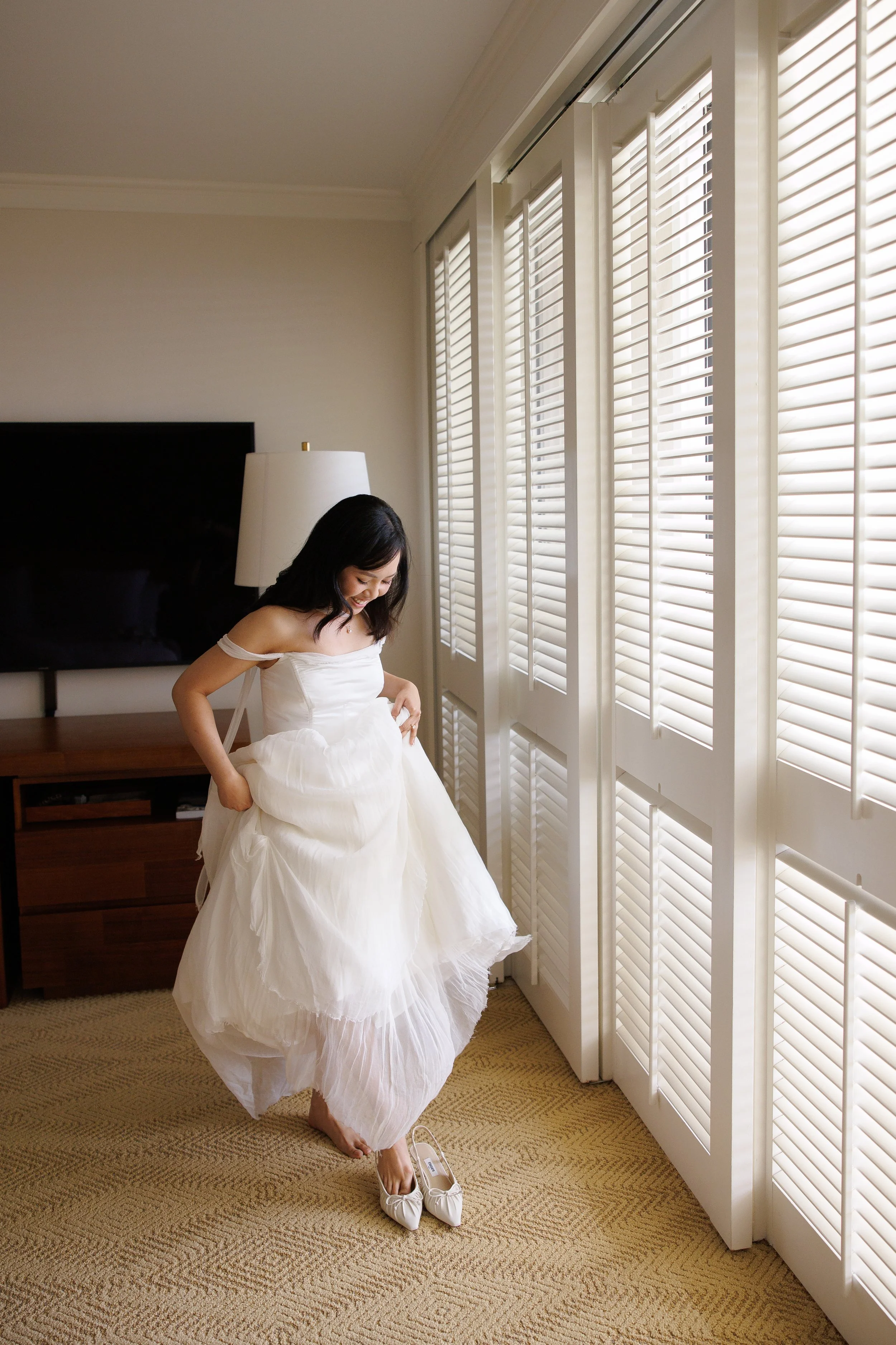 bride puts on shoes for gettin ready photo