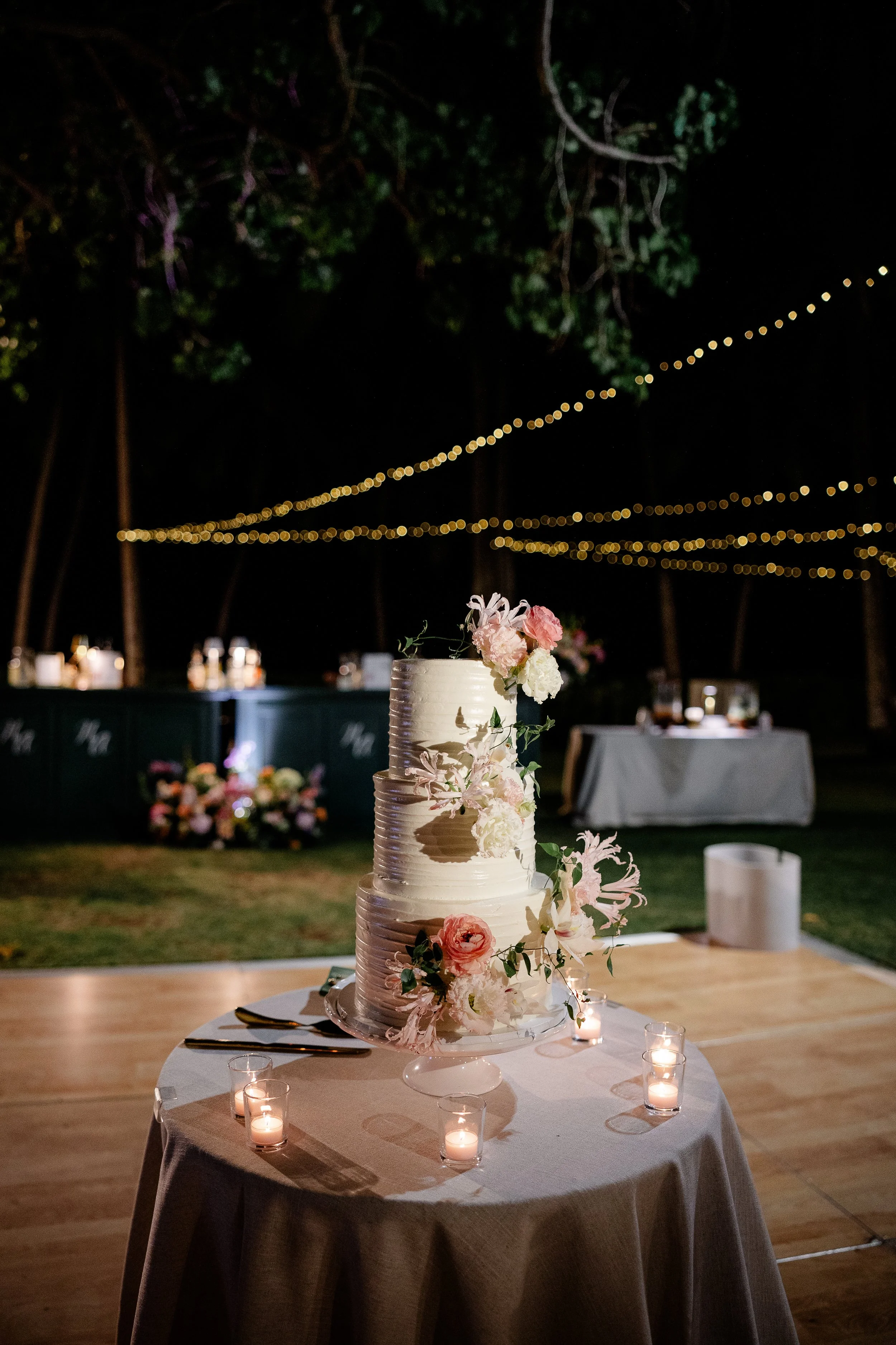 three tier wedding cake with flowers on each tier