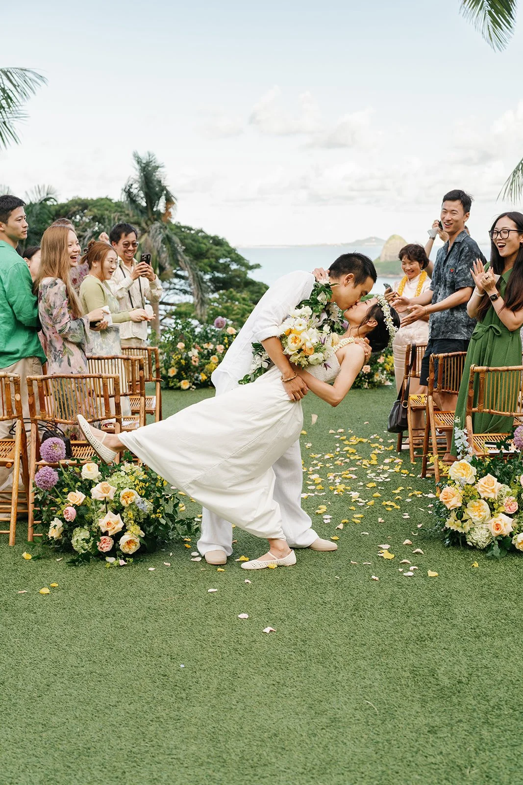 Groom dips bride and they share a kiss