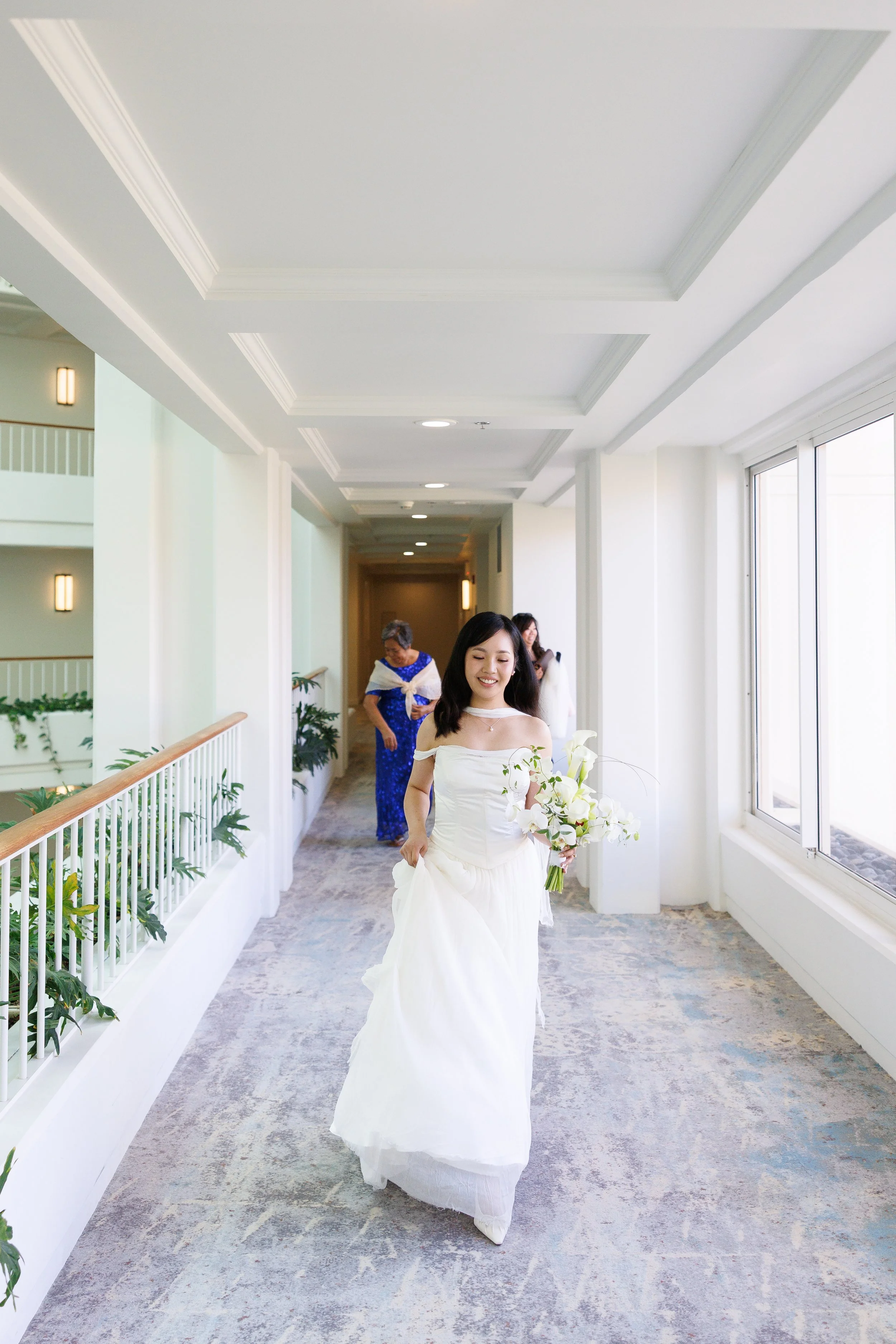 bride walking down hotel hallway
