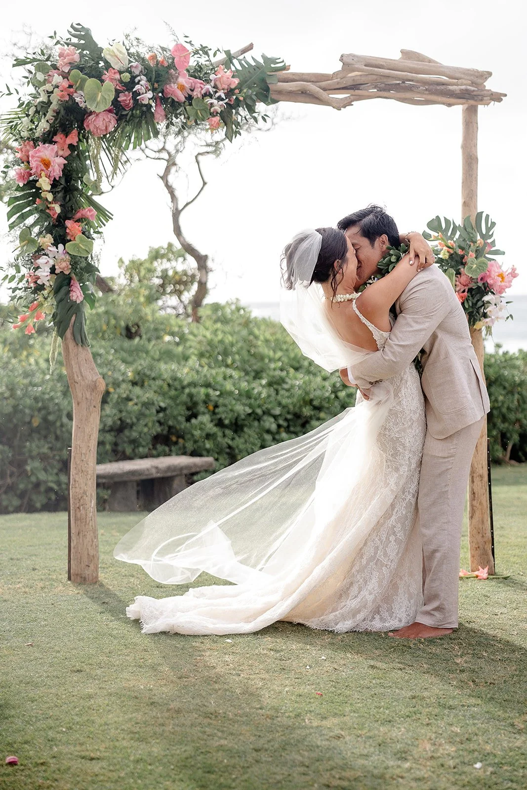 bride and groom kissing during ceremony in hawaii