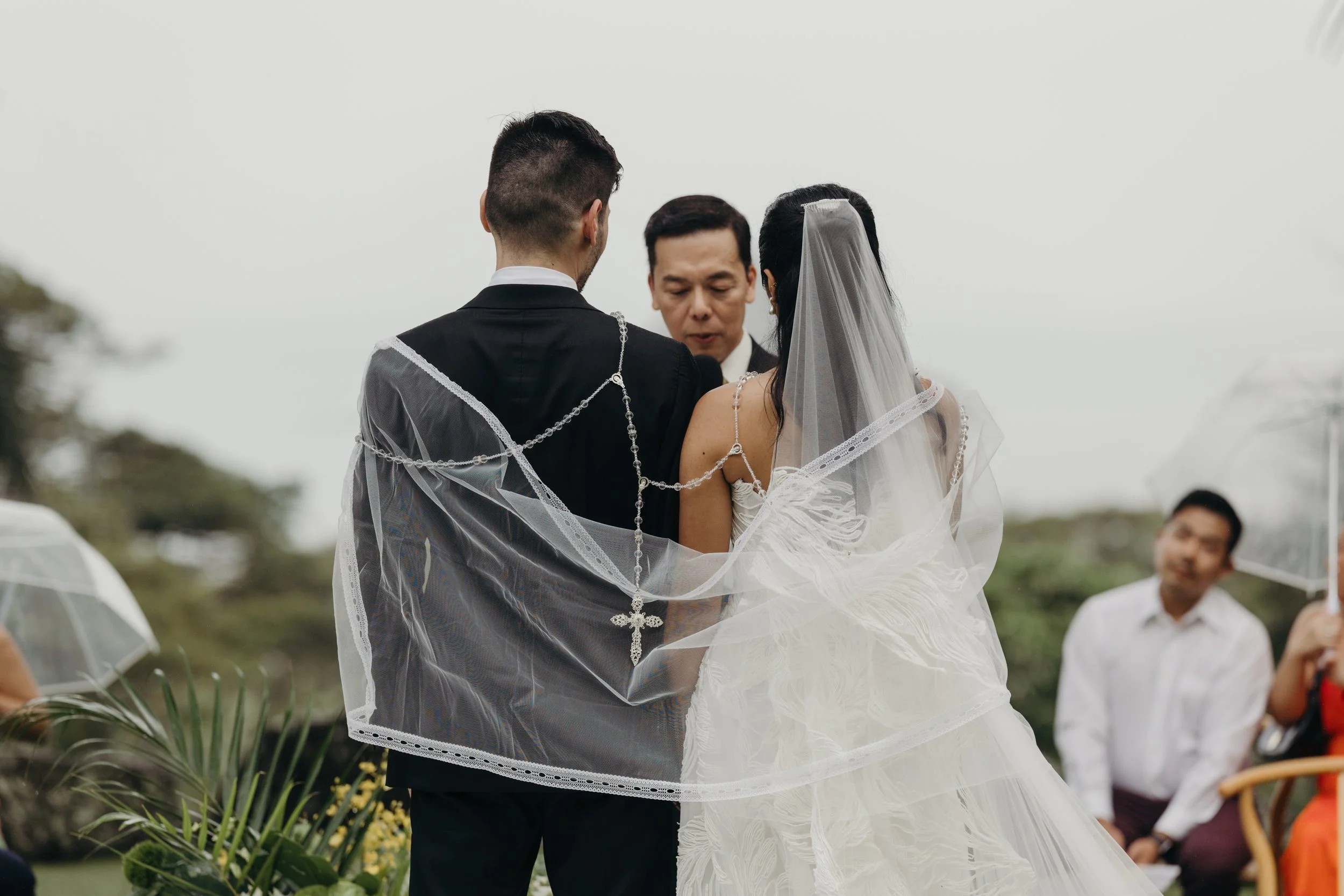 bride and groom with cross draped around them