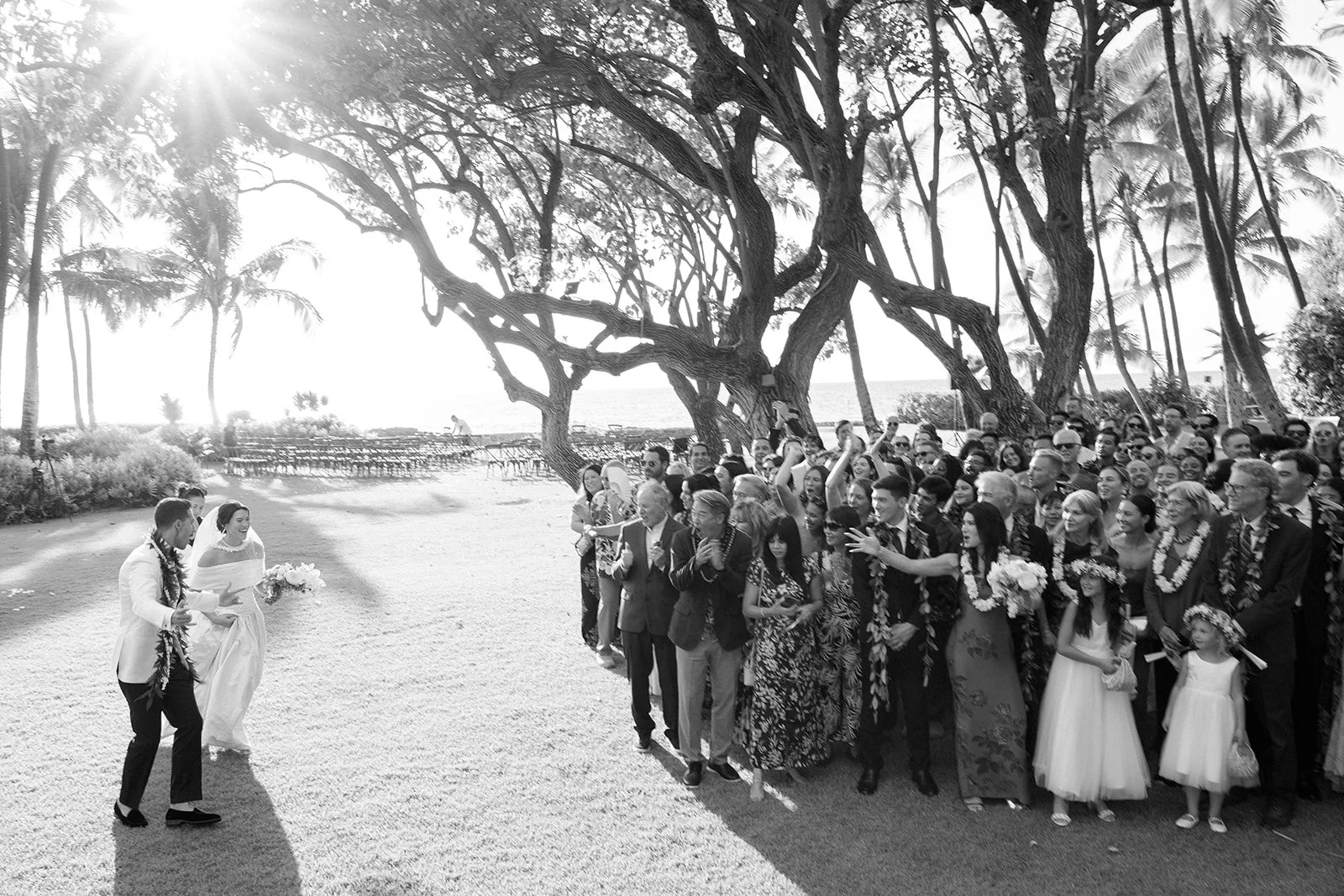 bride and groom running to guests at Hawaii wedding