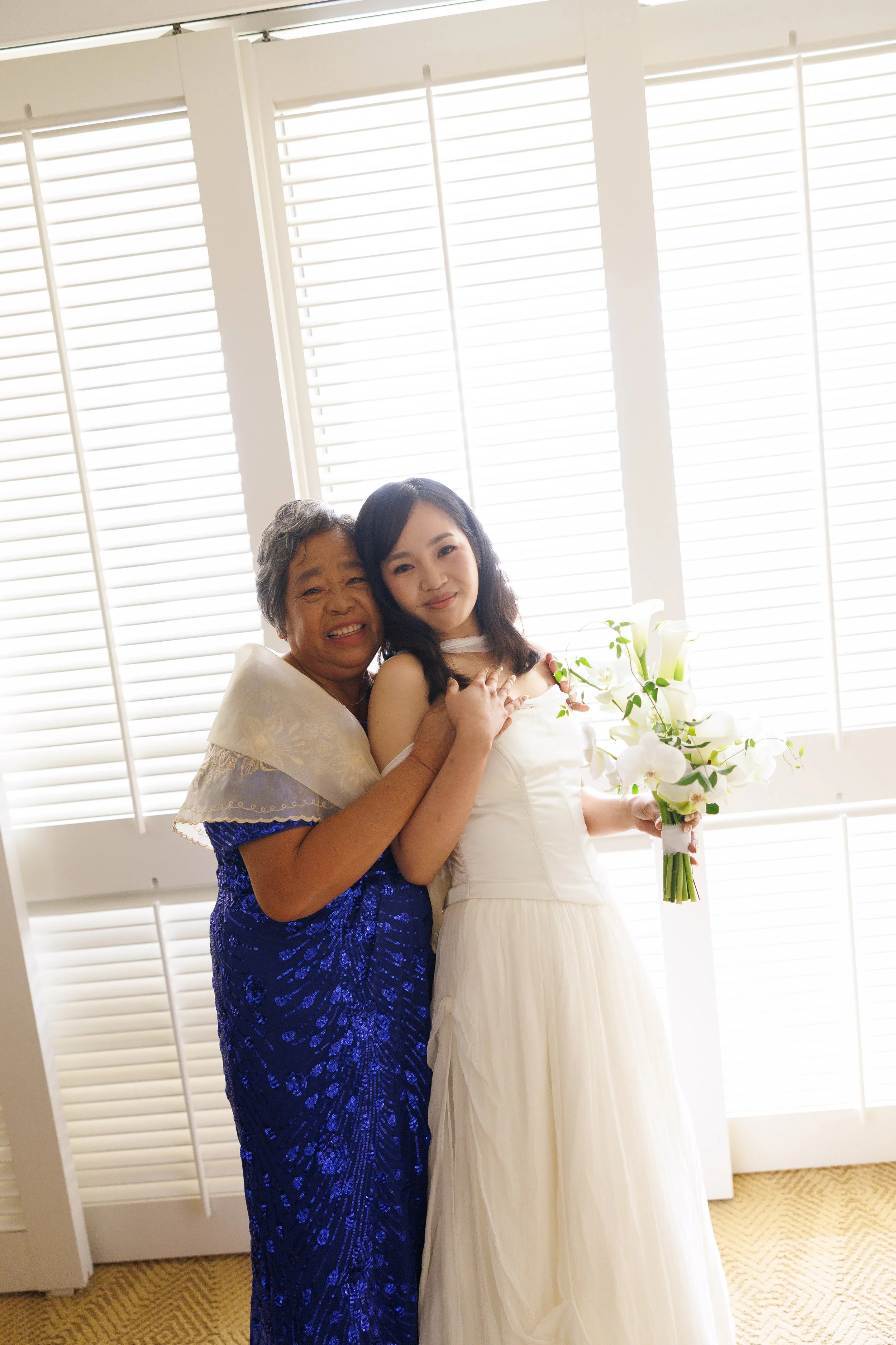 bride and mom smiling together