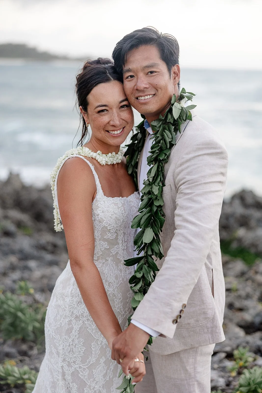 bride and groom by the ocean in hawaii