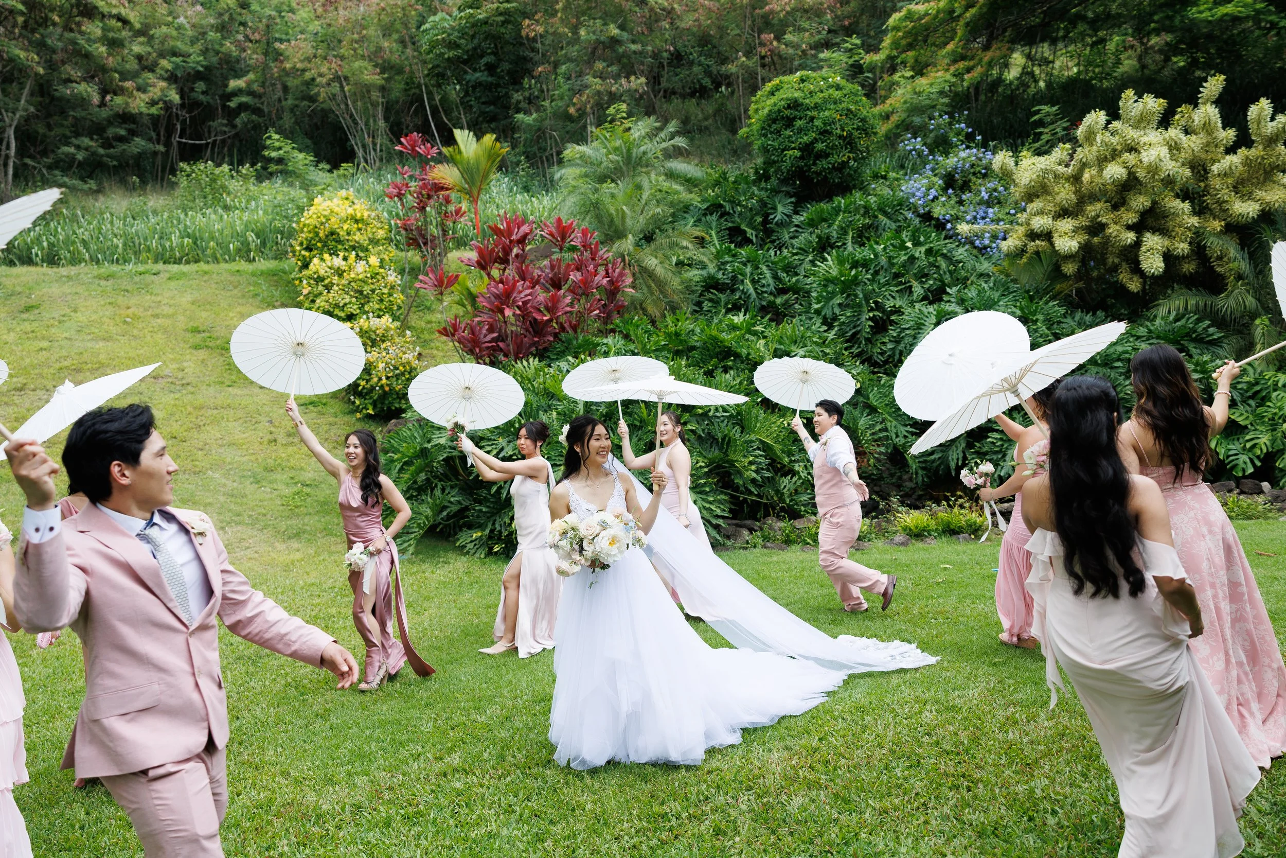 bride and bridal party with shade umbrellas