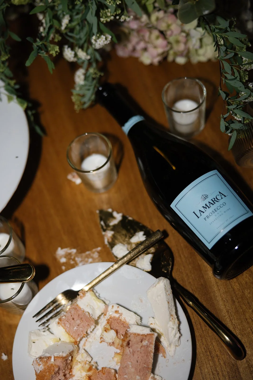Flat lay of wedding cake plate and empty champagne bottle, styled by Oahu wedding planner Love Letter Weddings at Paliku Gardens