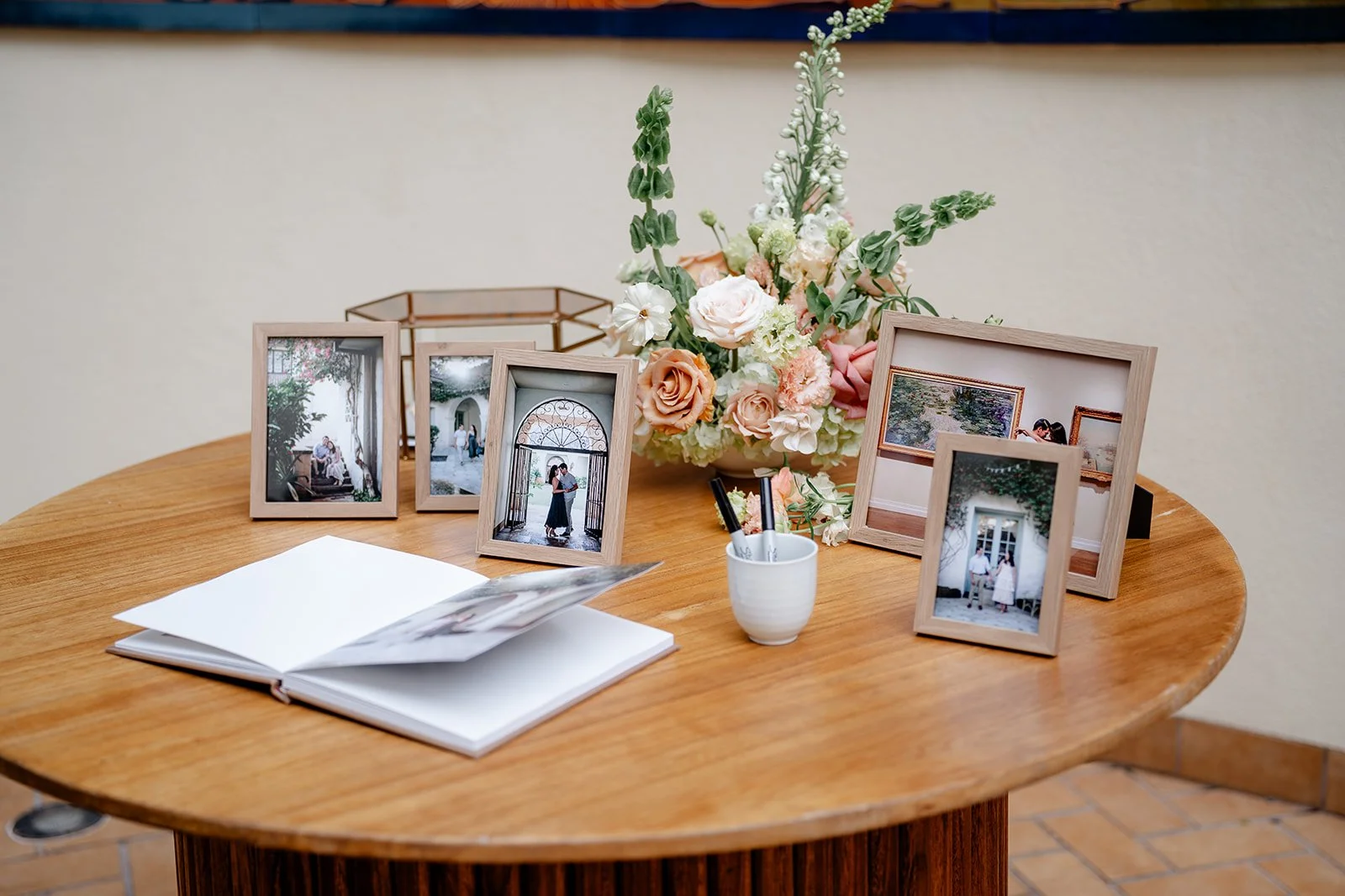 bride and groom photos on welcome table