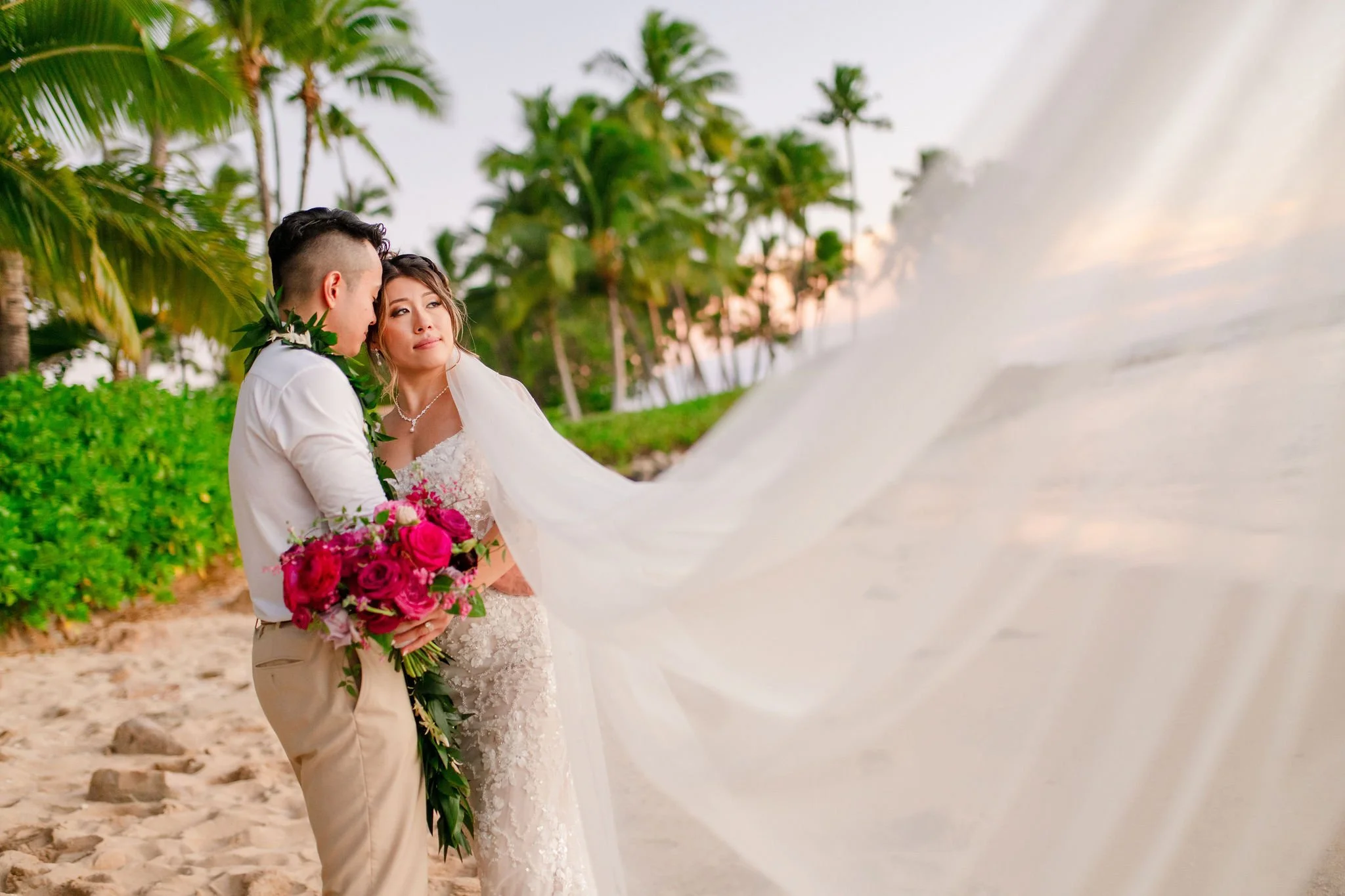 bride and groom on beach in hawaii