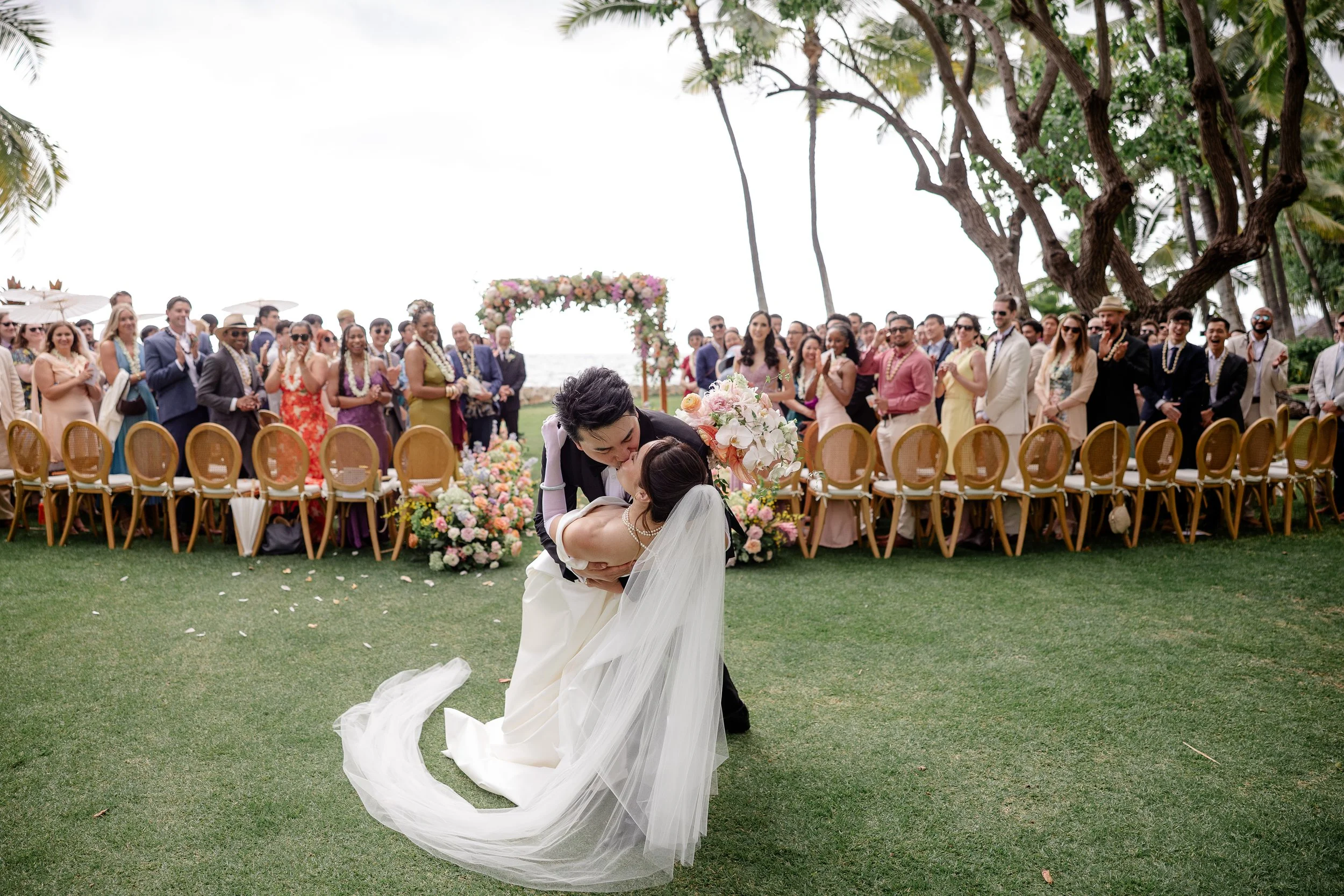 groom dips bride as they kiss