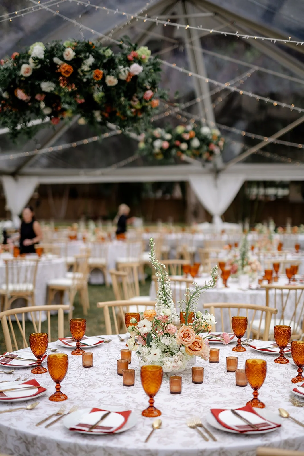 wedding table with red napkins and amber glasses