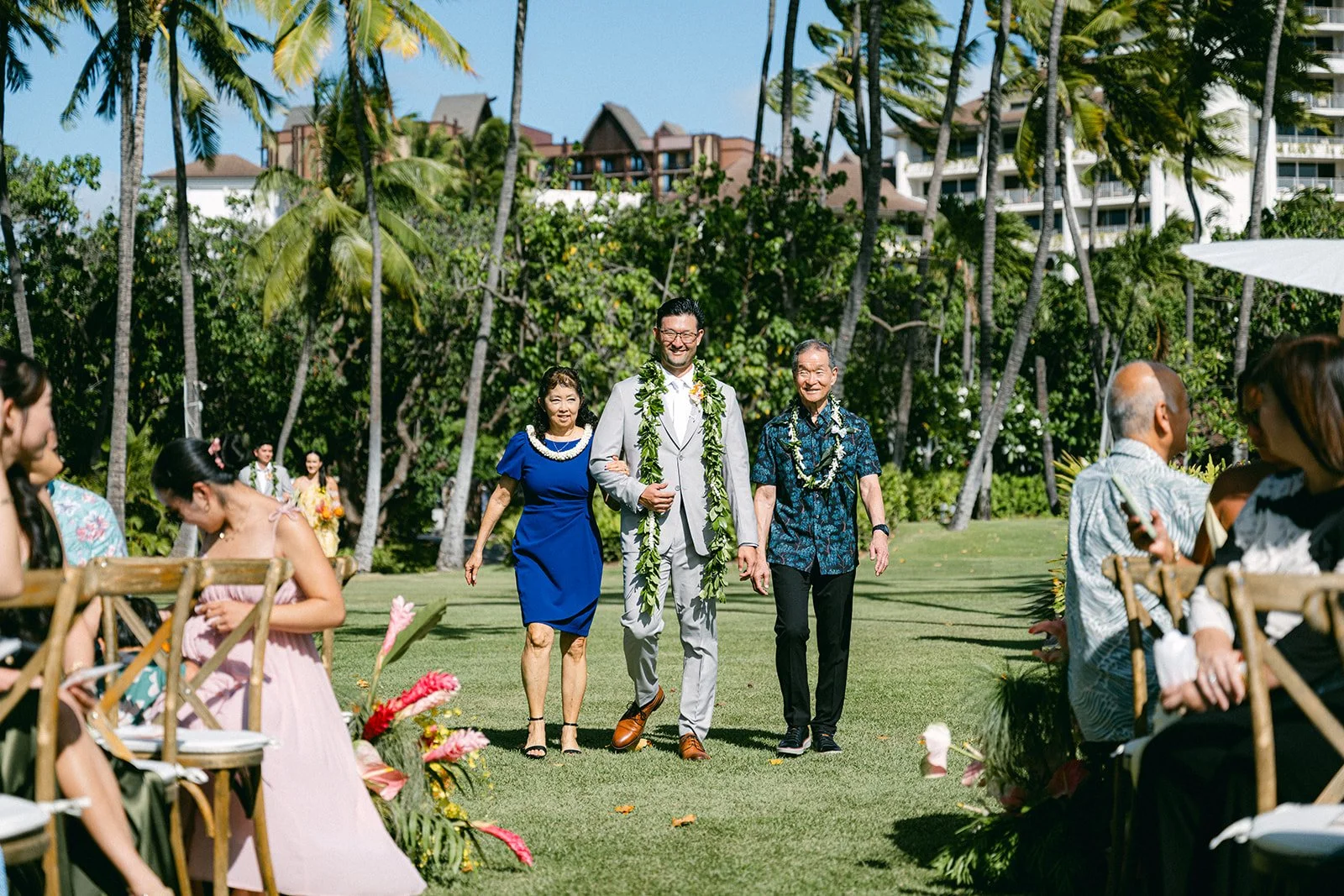 groom walking with parents down the aisle