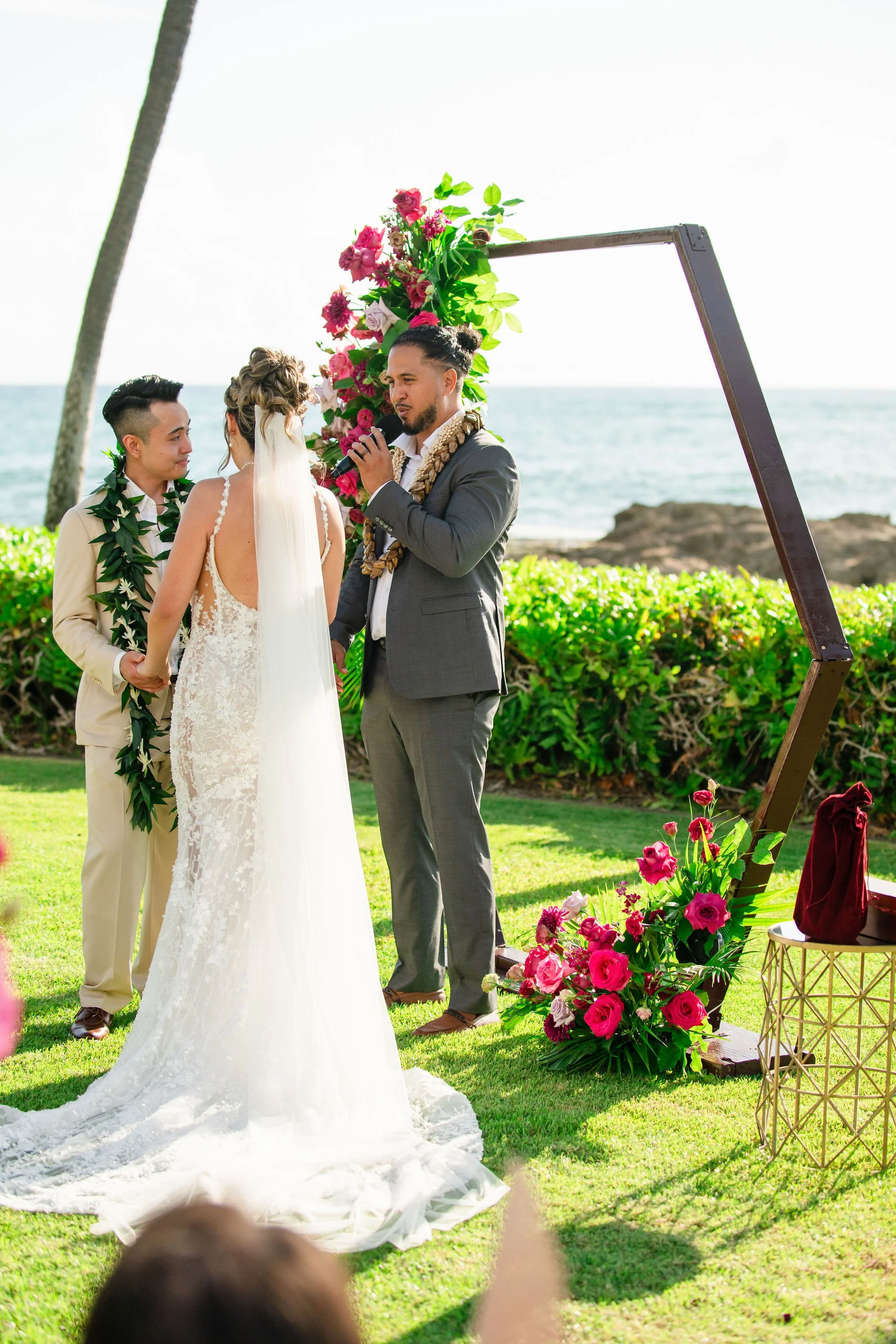 bride and groom and officiant during ceremony in hawaii