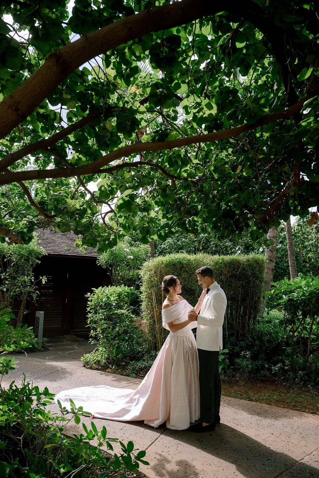 bride and groom in front of greenery