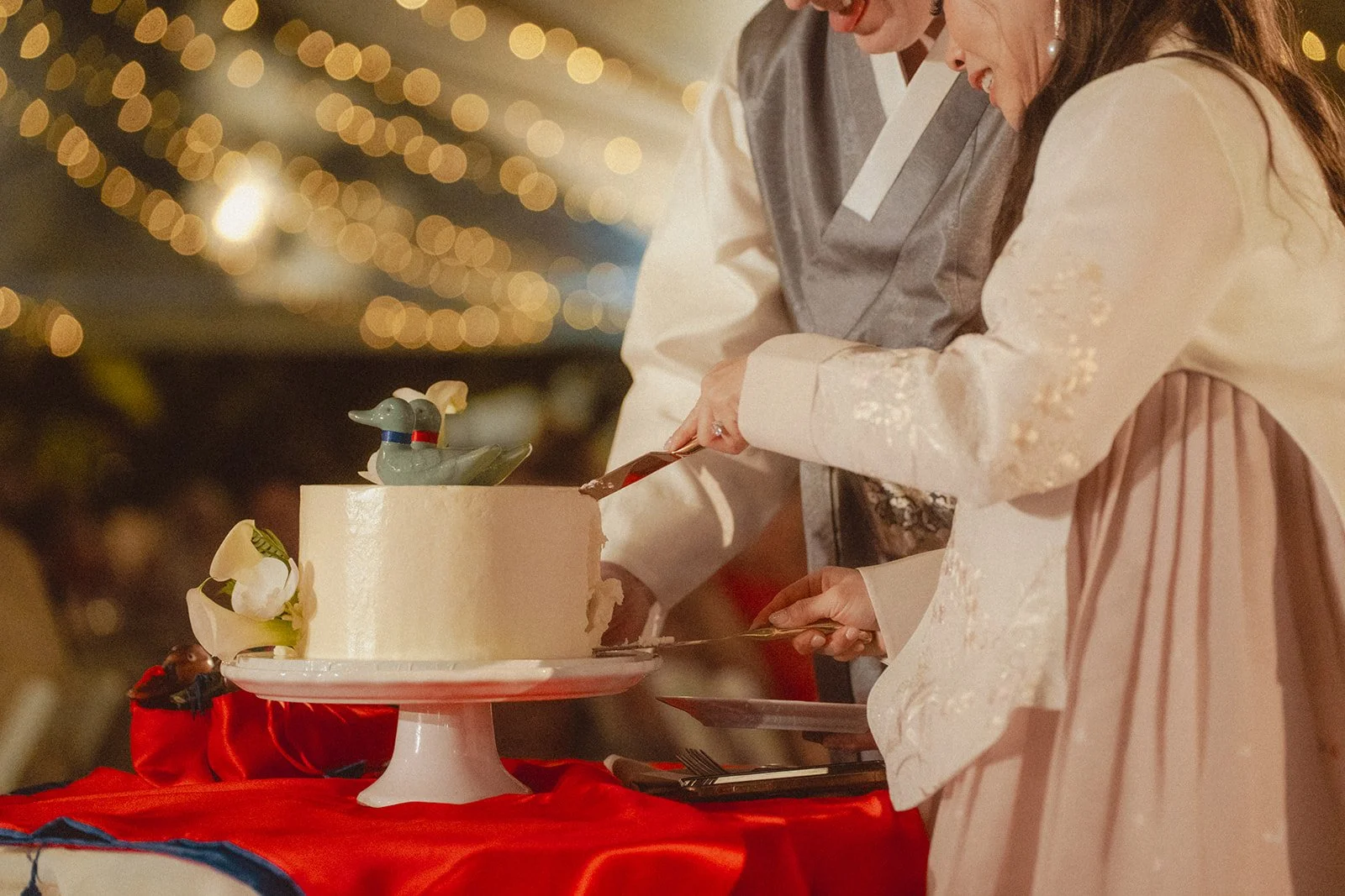bride and groom cutting cake