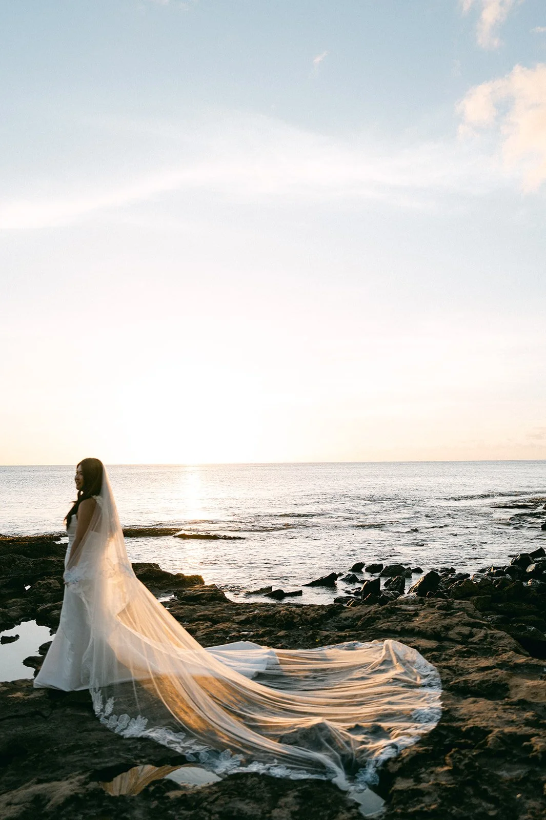 bride walking on beach in hawaii