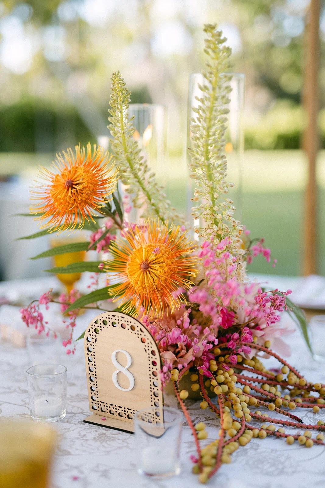wood table number with pink orange and yellow flowers