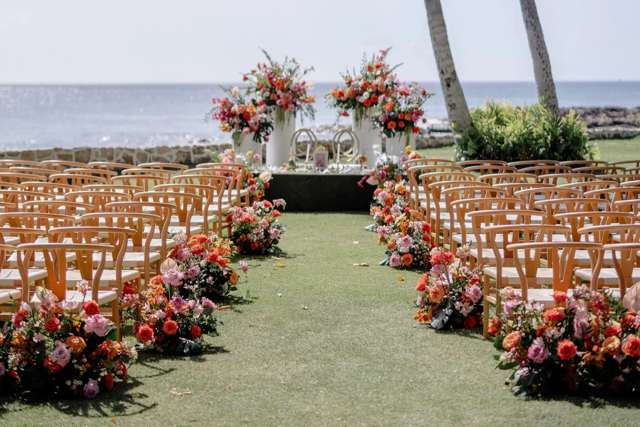 wedding ceremony in Hawaii with pink, orange and purple flowers