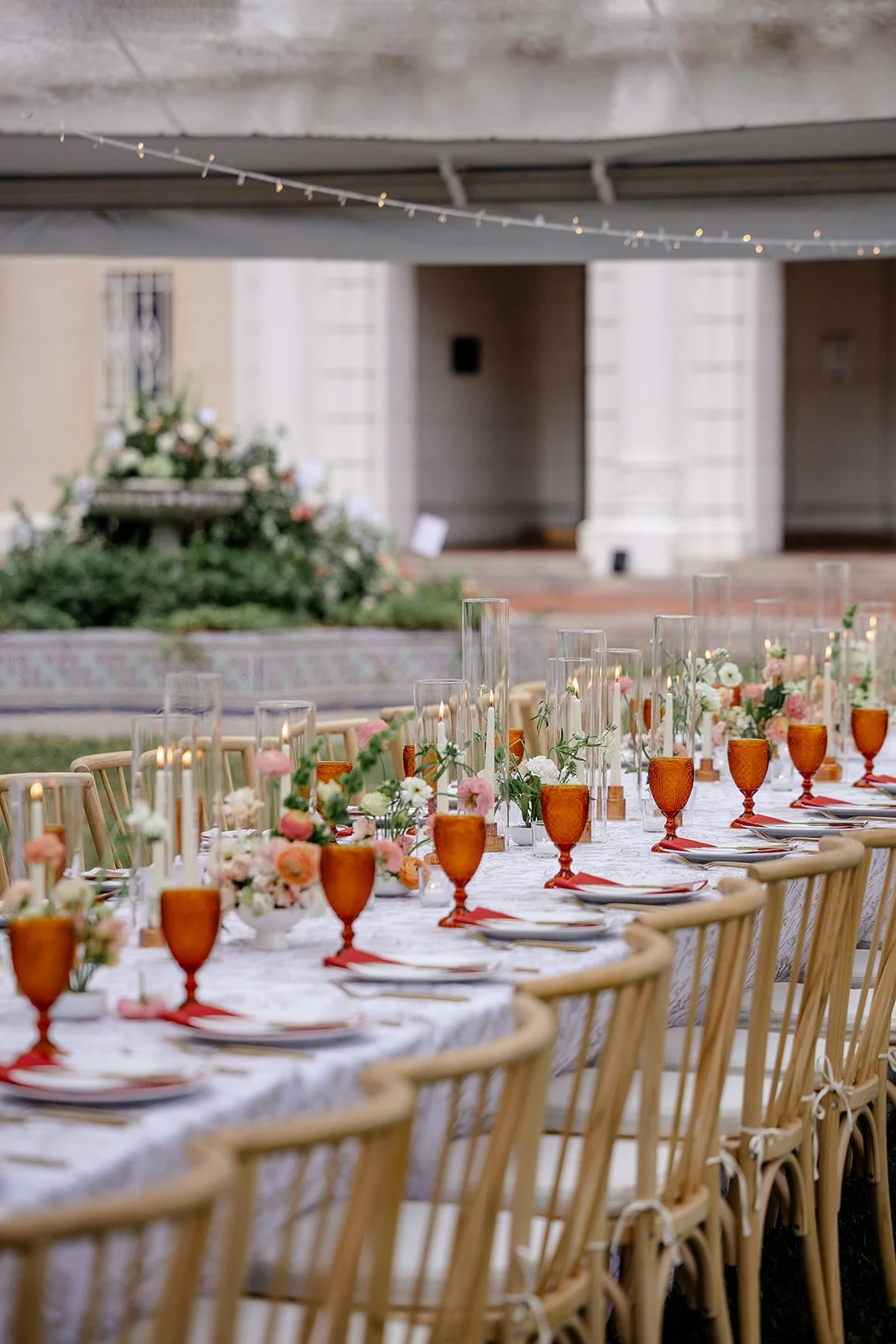 wedding table with red napkins and amber glasses