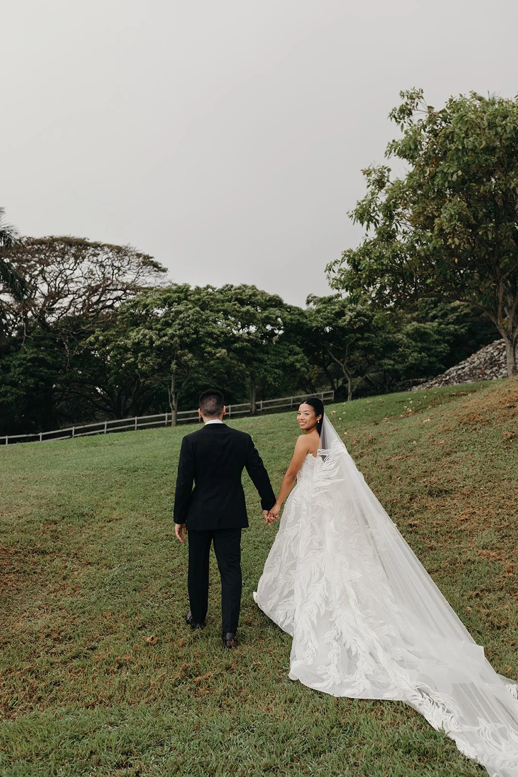 bride and groom in field in hawaii
