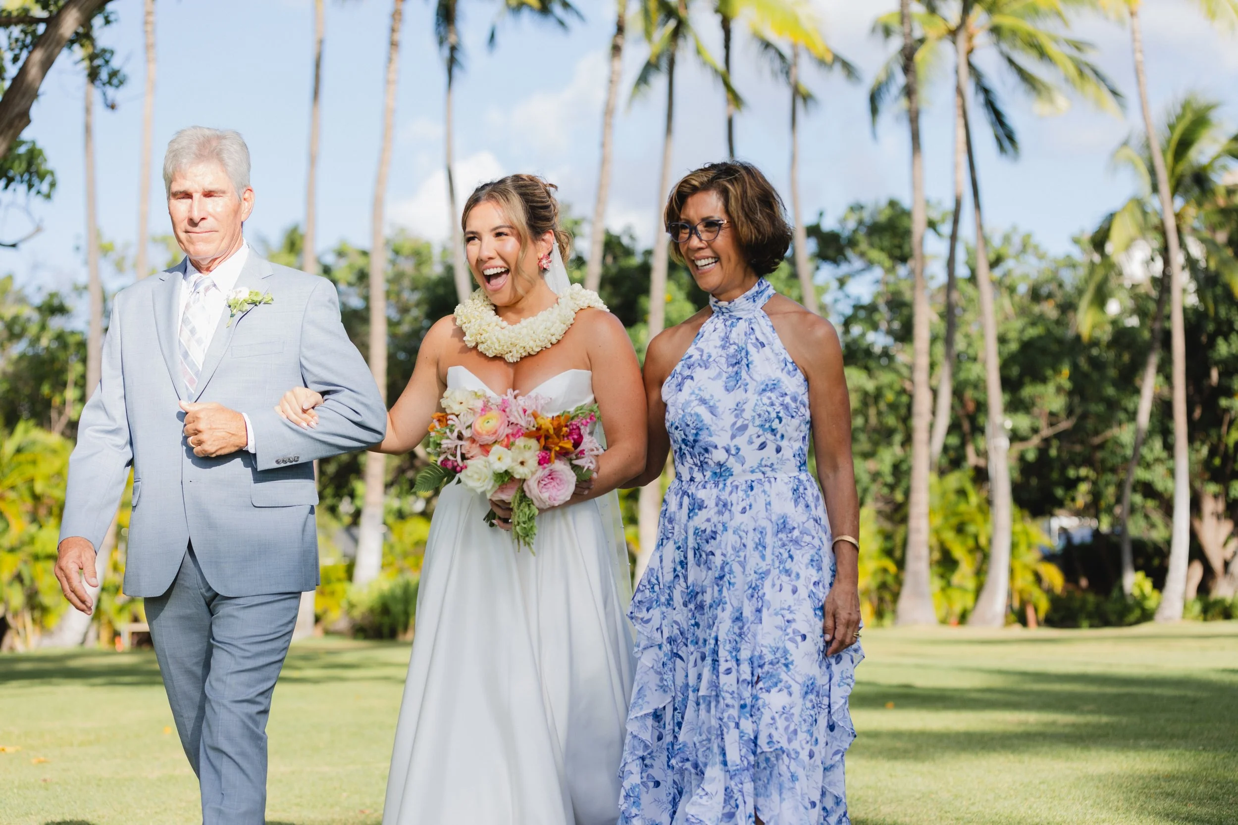 bride walking down aisle with mom and dad