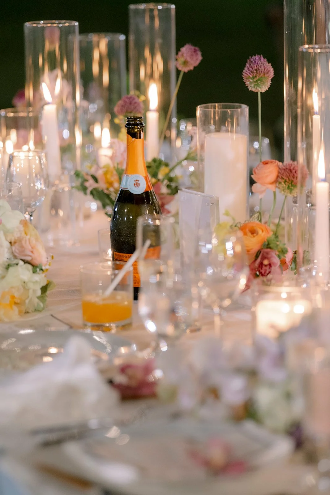 champagne bottle on table with candles