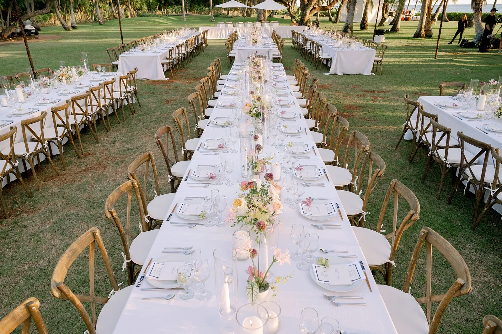 wedding reception with candles, pastel florals, and white linens