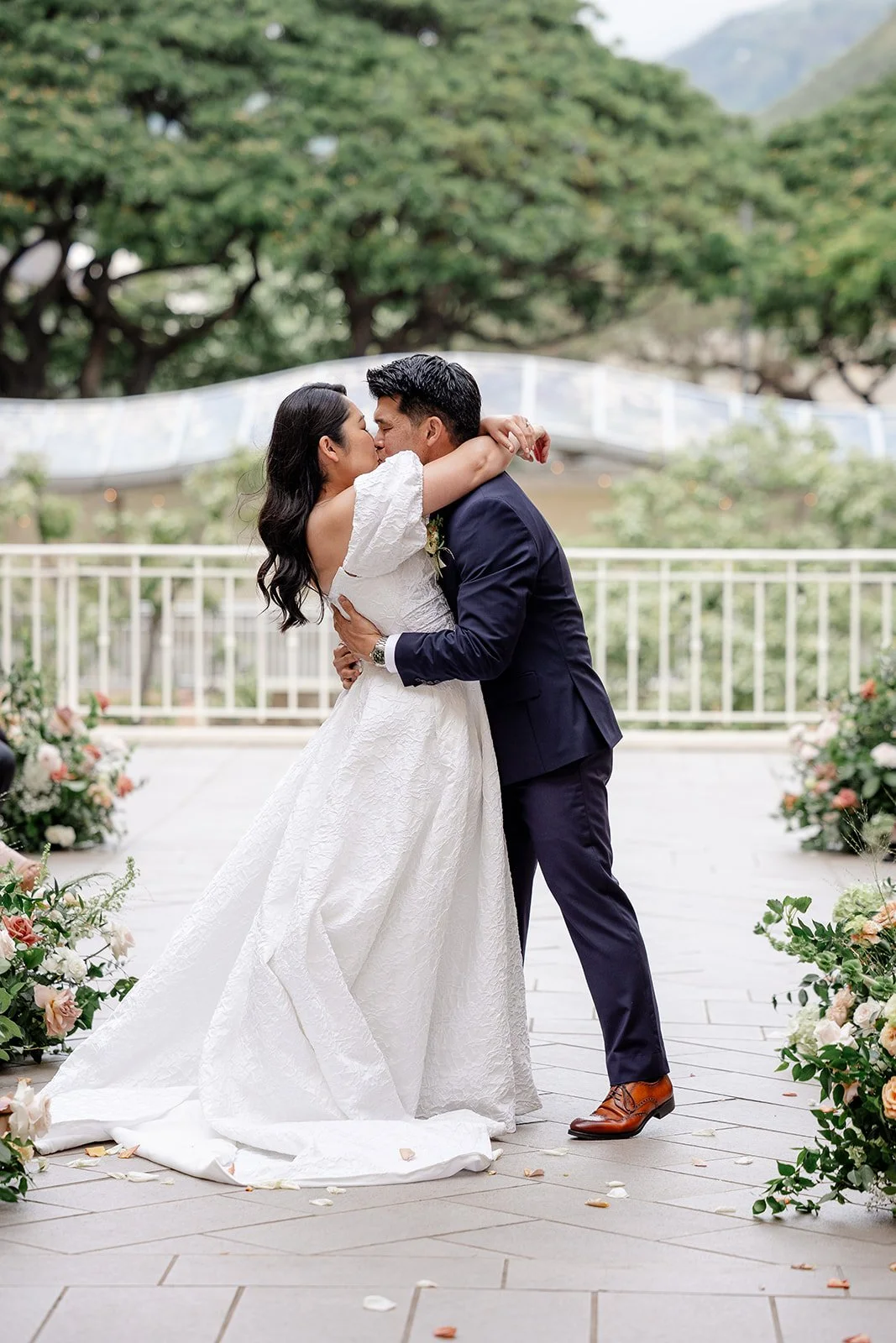 bride and groom kissing during wedding ceremony