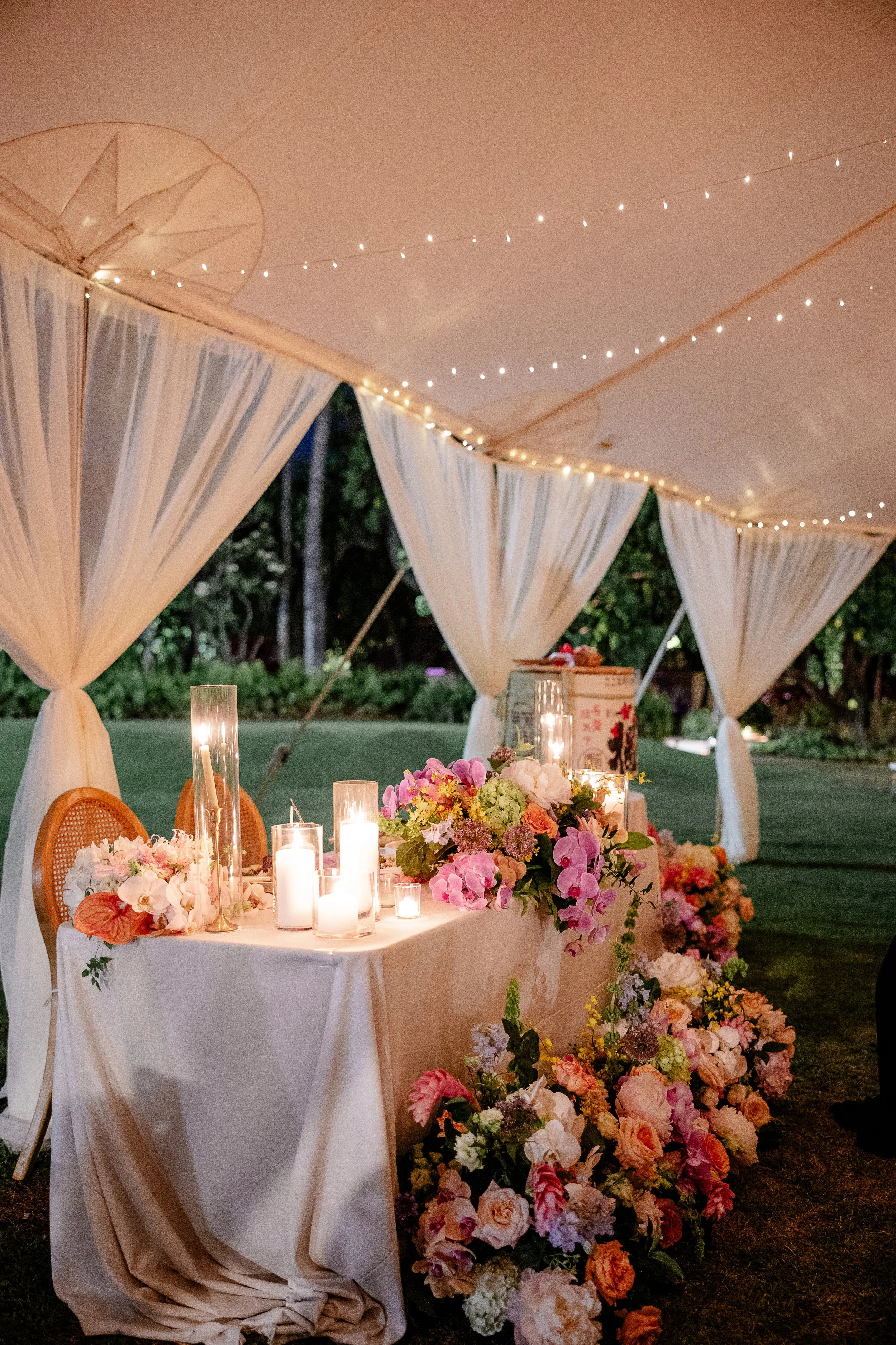sweetheart table with flower arrangements and candles