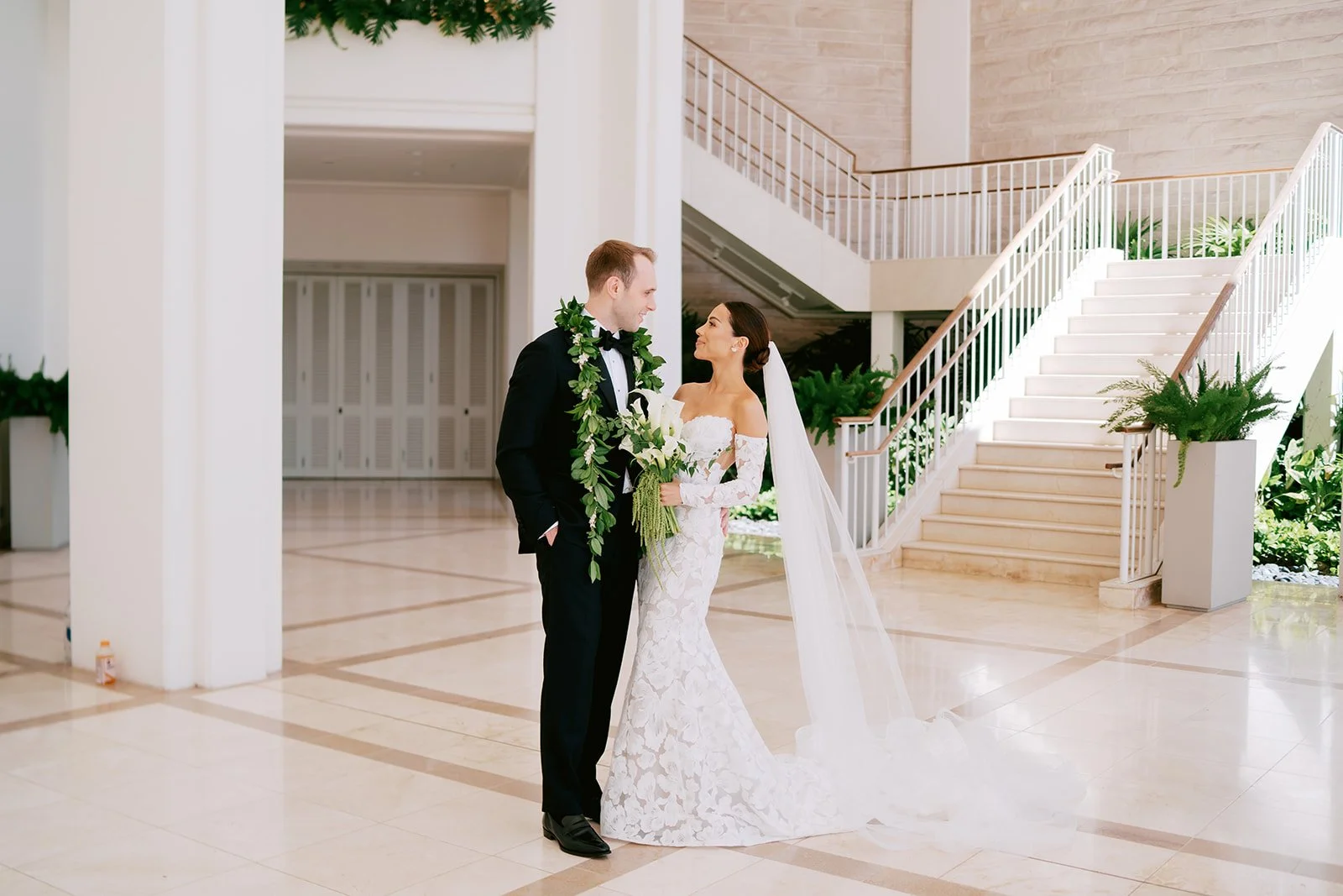 Bride and groom by marble staircase