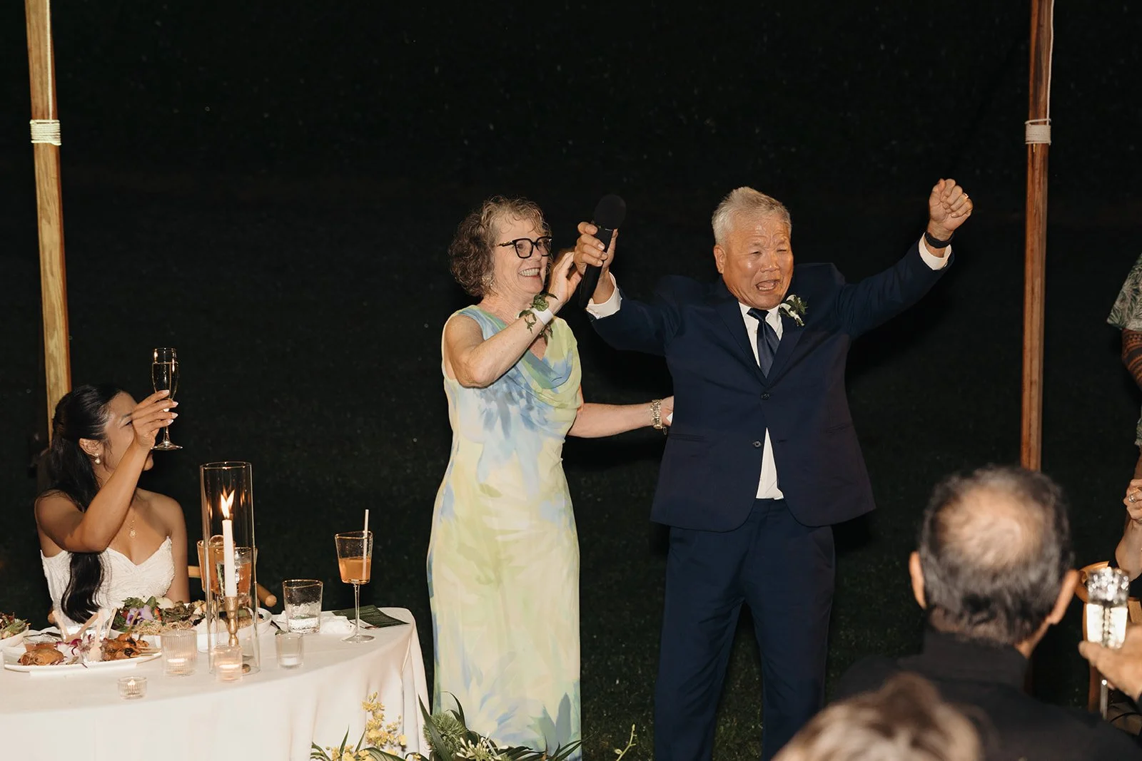 grooms parents giving speech at wedding