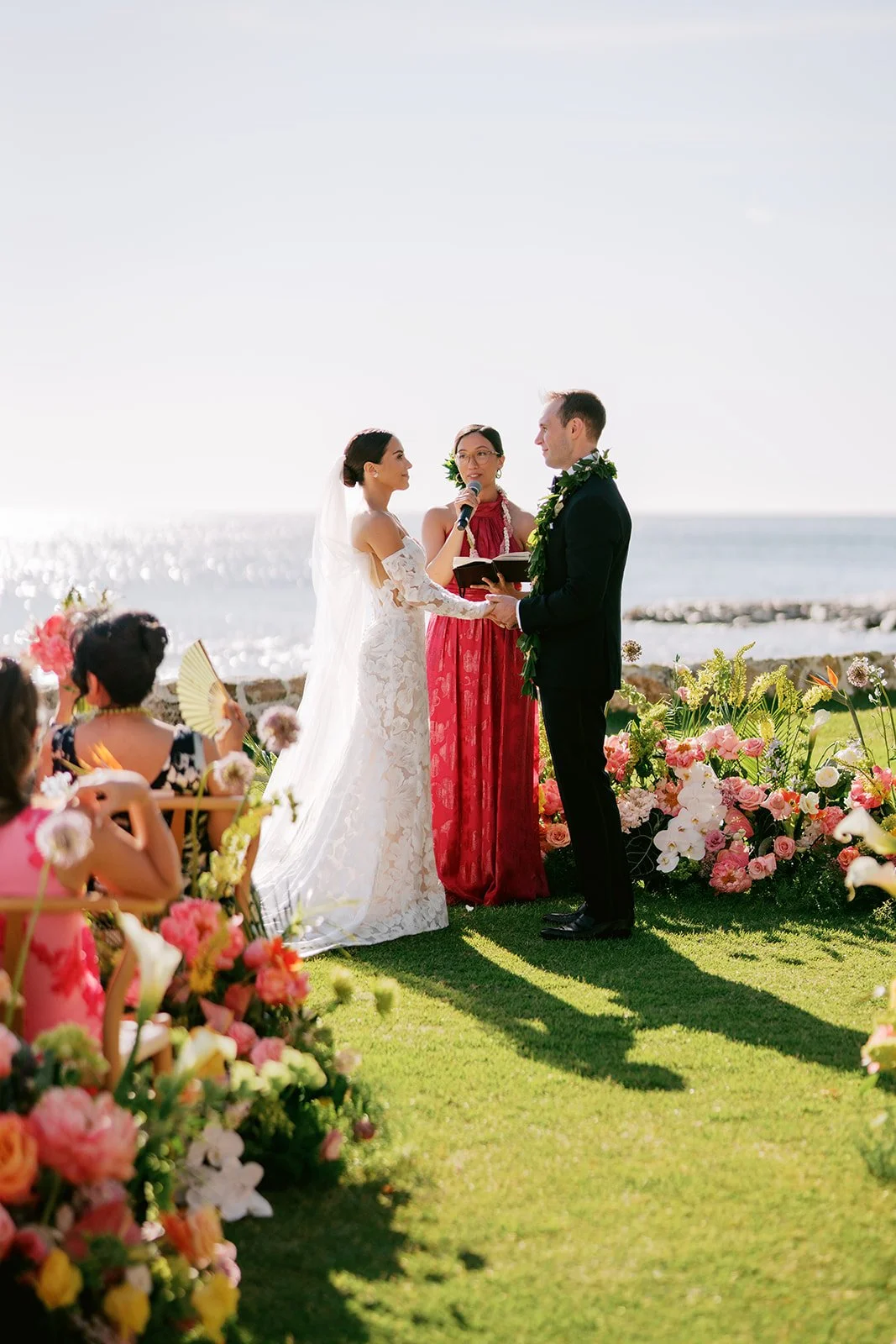 bride and groom getting married by the beach in hawaii
