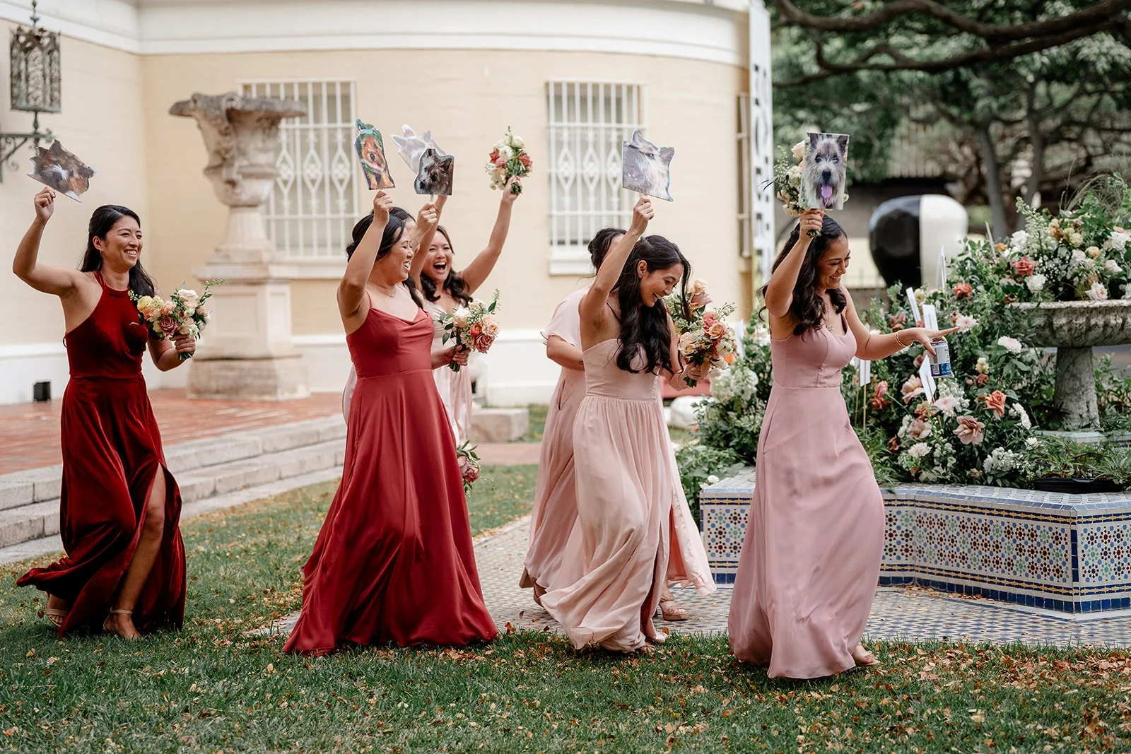 bridesmaids holding photos of the couples dog