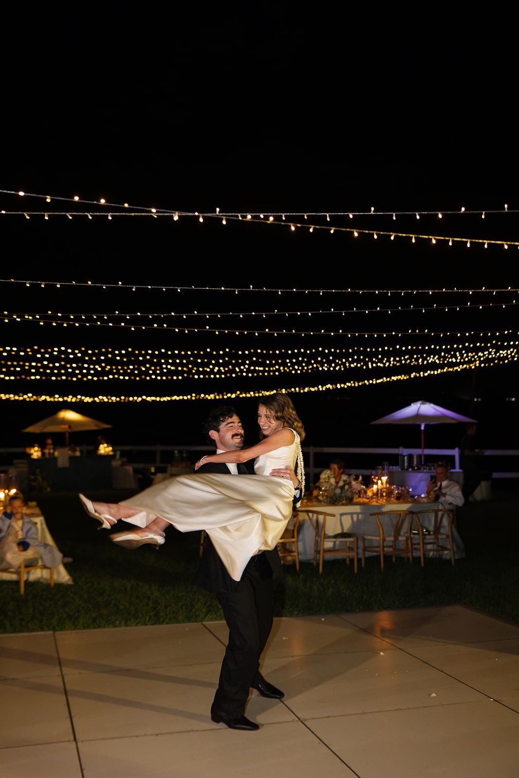 Groom lifts bride during their first dance at this Paliku Gardens wedding, planned by Oahu wedding planner Love Letter Weddings