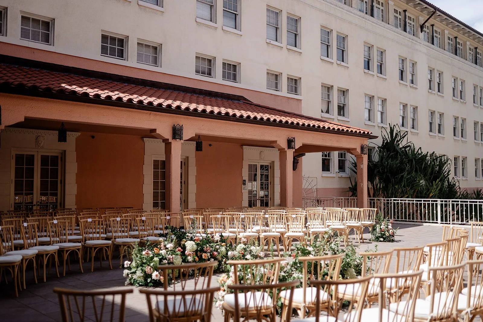pink and mauve wedding ceremony flowers and chairs at museum