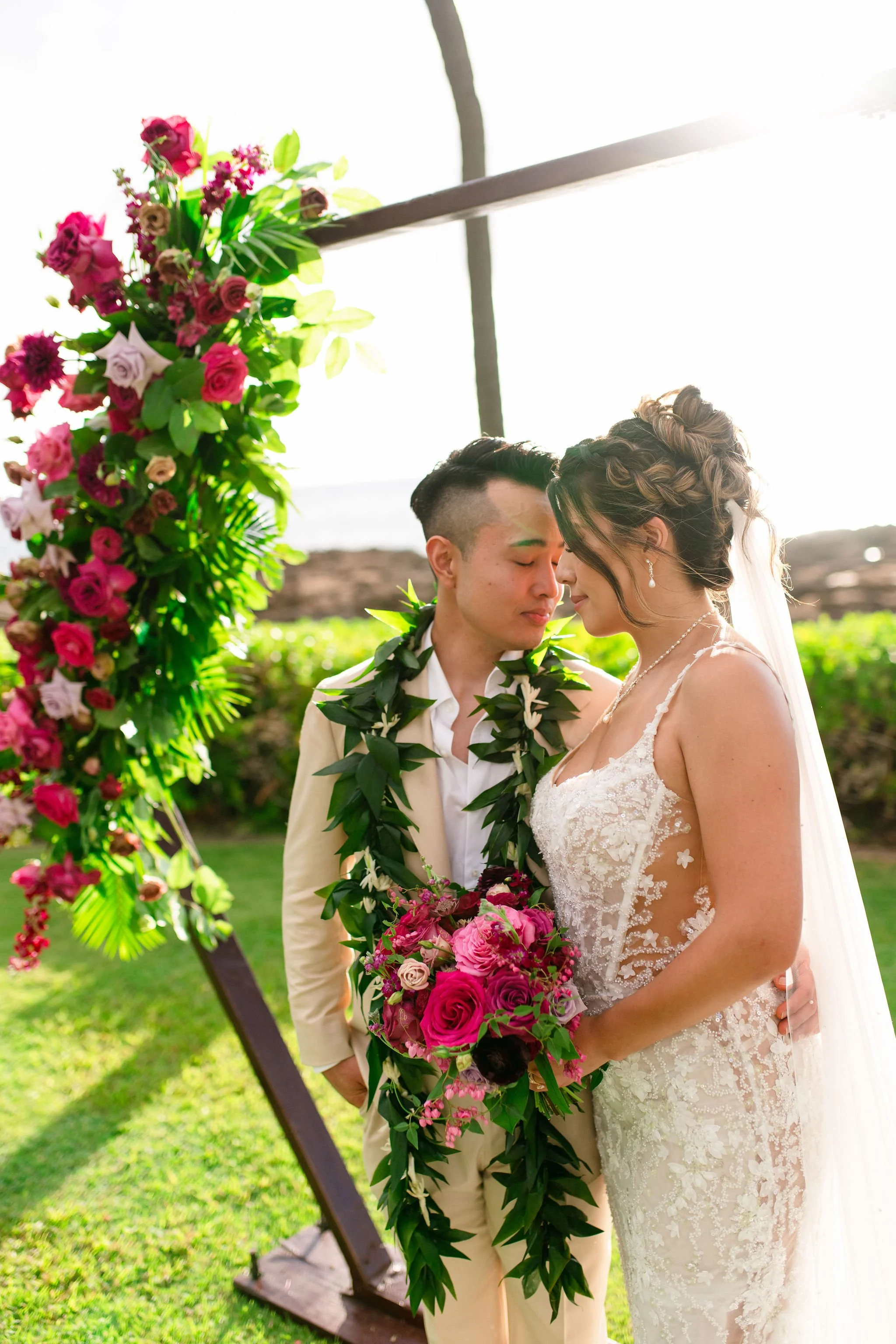 bride and groom in front on wedding altar near beach in hawaii