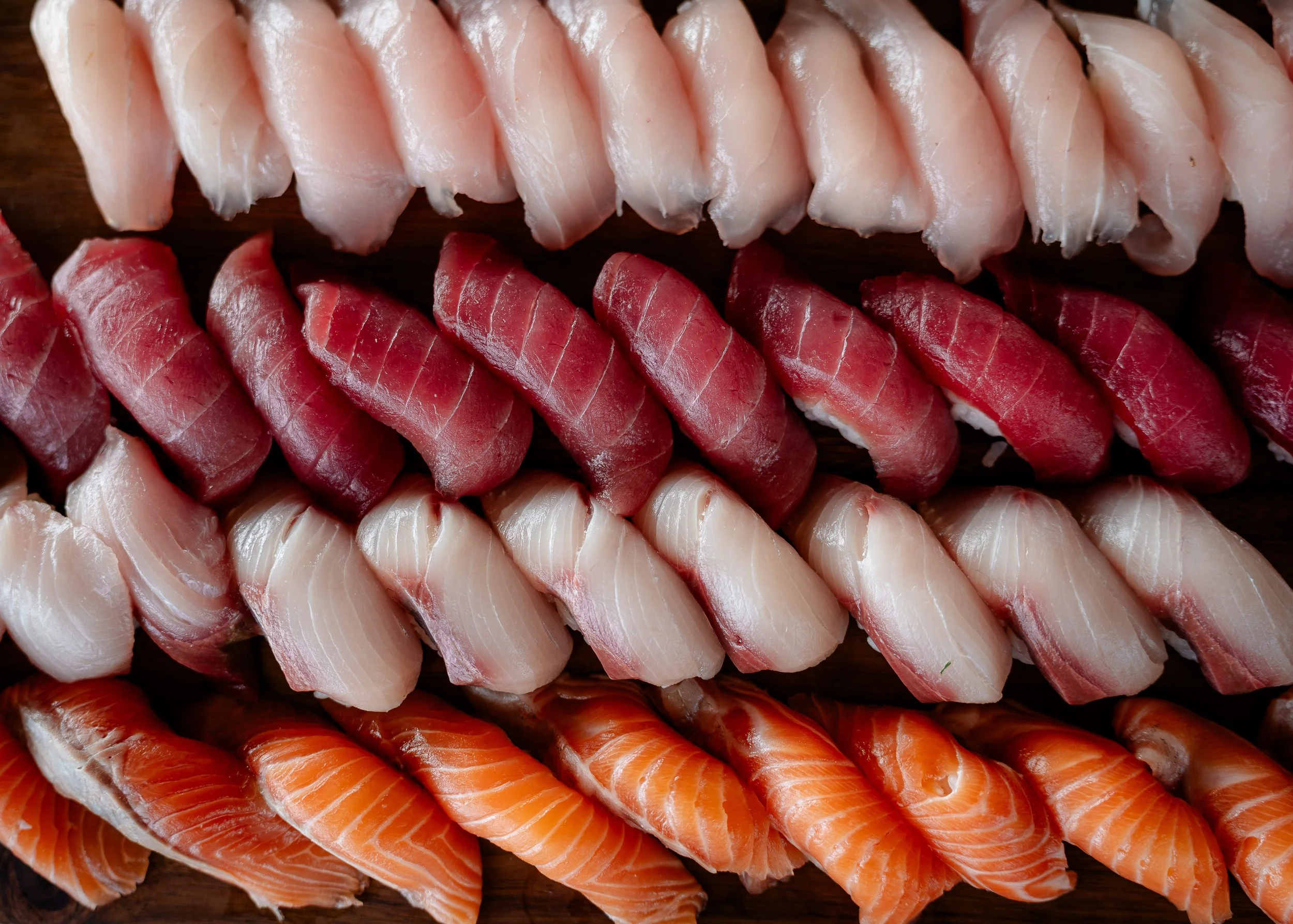 varieties of sushi lined up in a row
