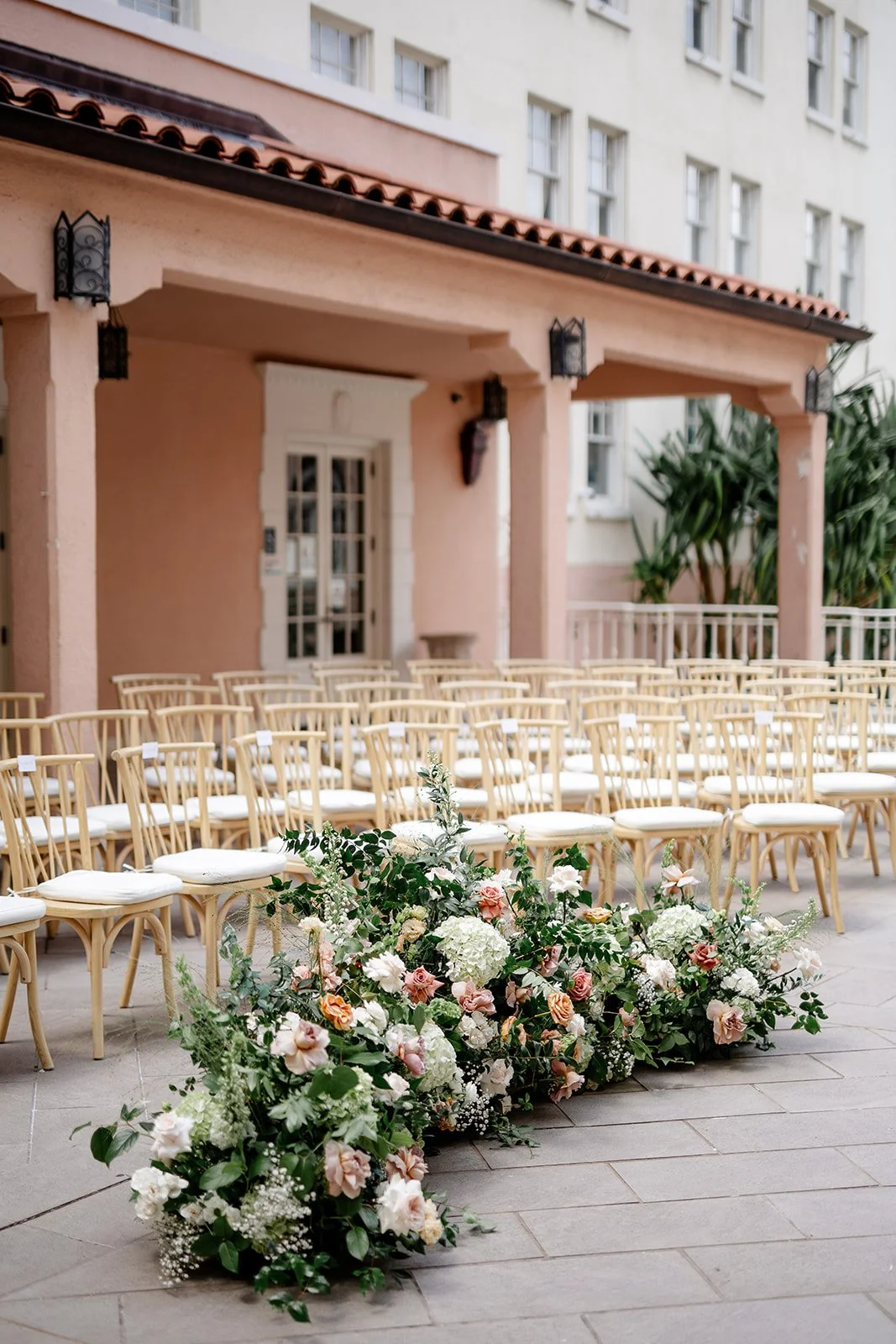 light pink and mauve wedding ceremony flowers