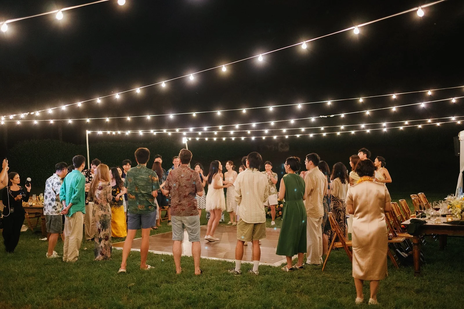 Guests in a group around the dance floor playing a game