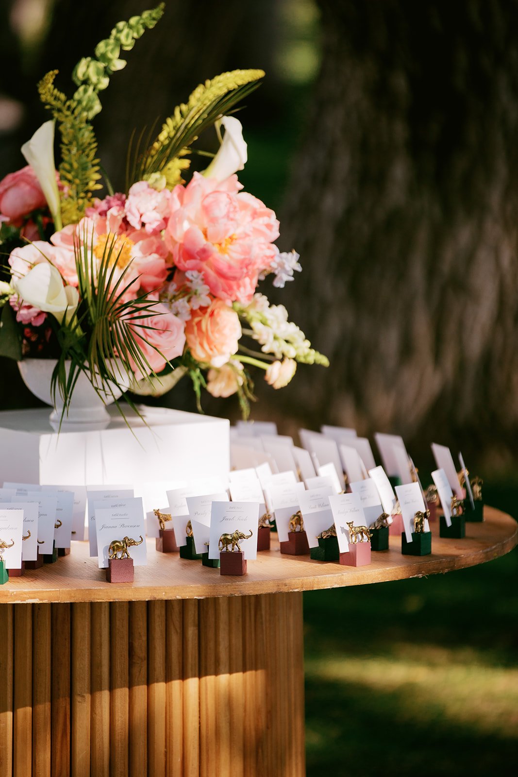 wedding seating chart with gold animals and colorful florals