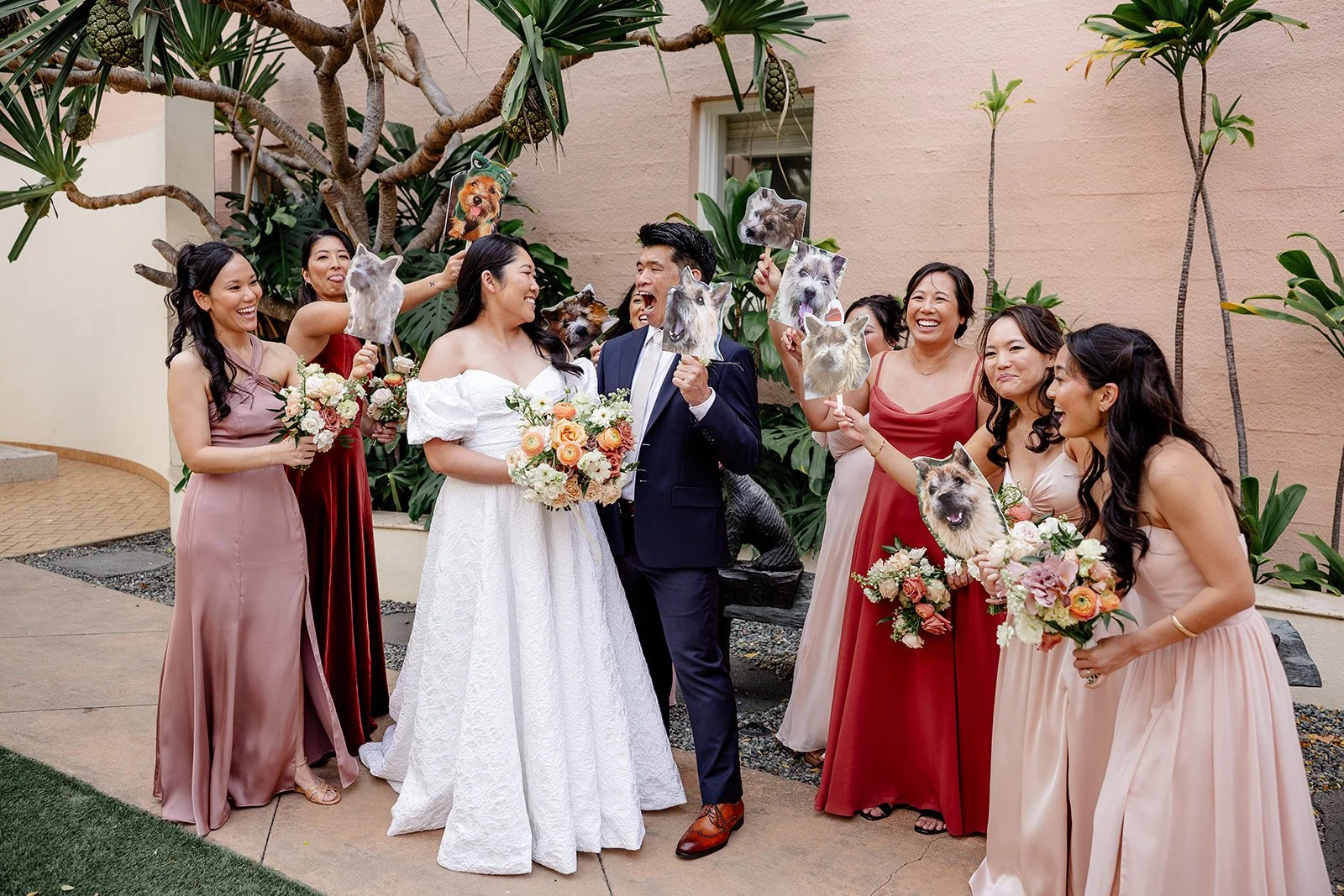bride and groom with bridesmaids holding picture of their dogs