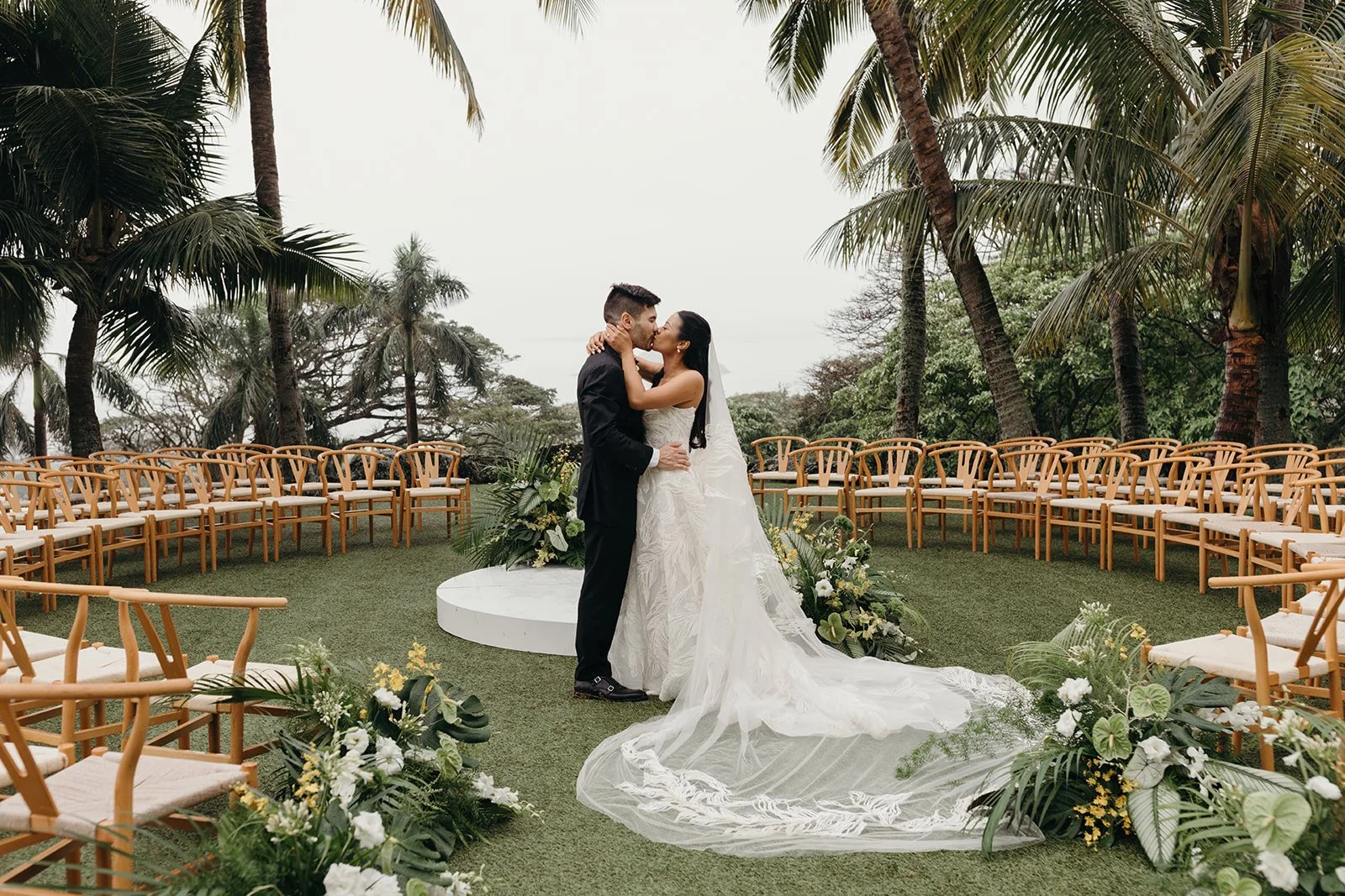 bride and groom kissing at wedding ceremony in hawaii