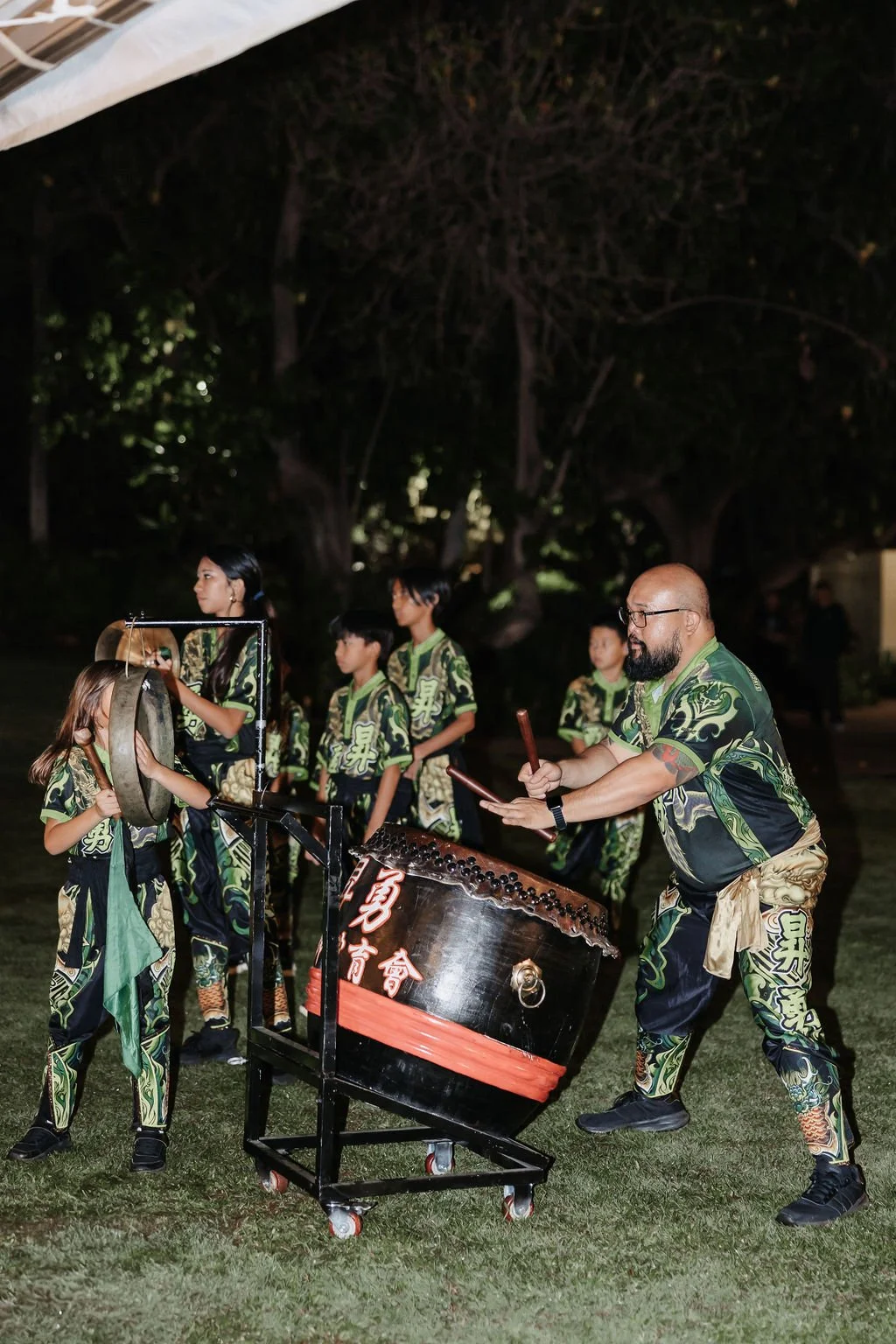 Percussionists perform for traditional Chinese Lion Dance during Hawaii wedding reception.