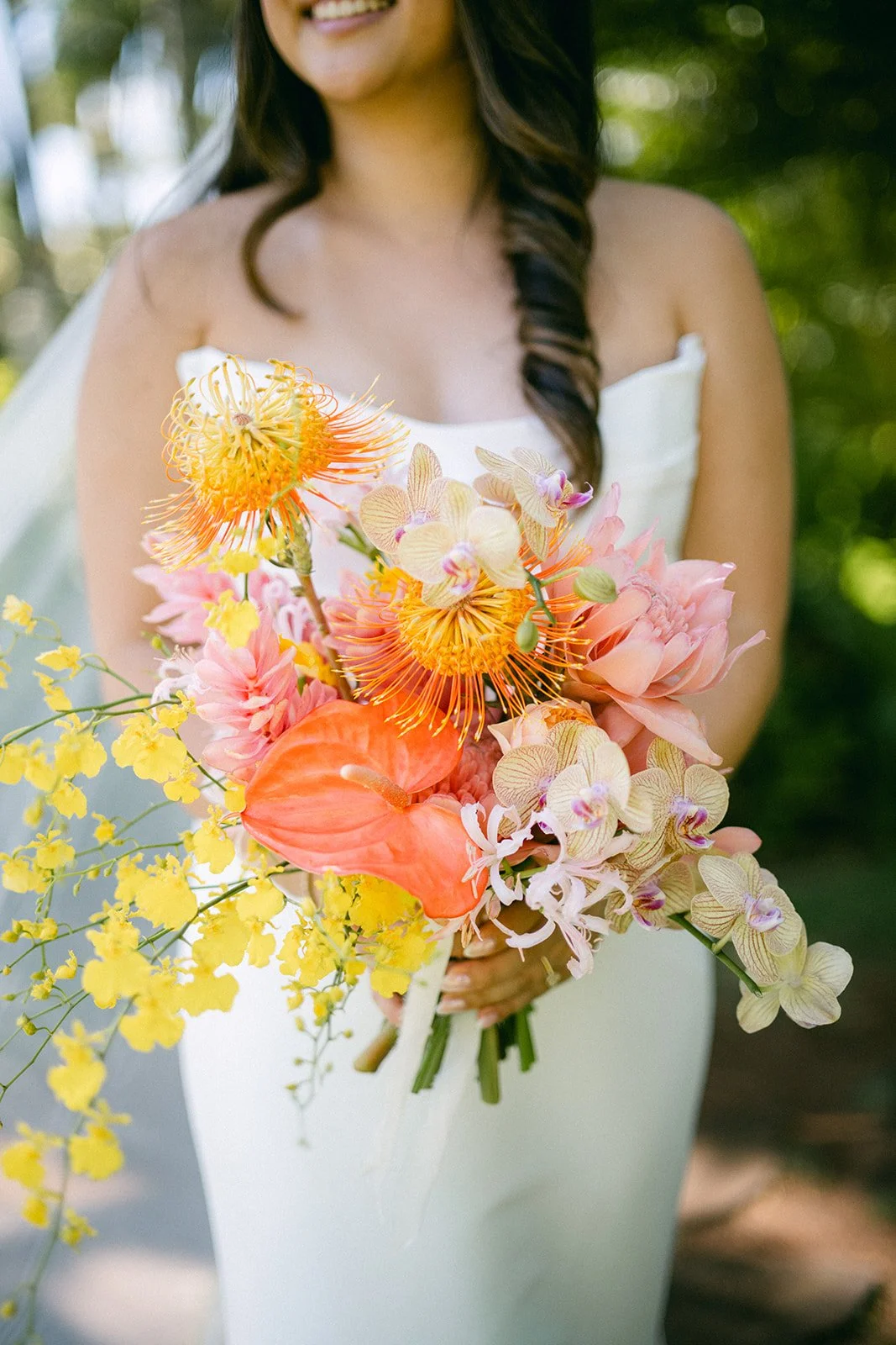 bride with pink orange and yellow bouquet