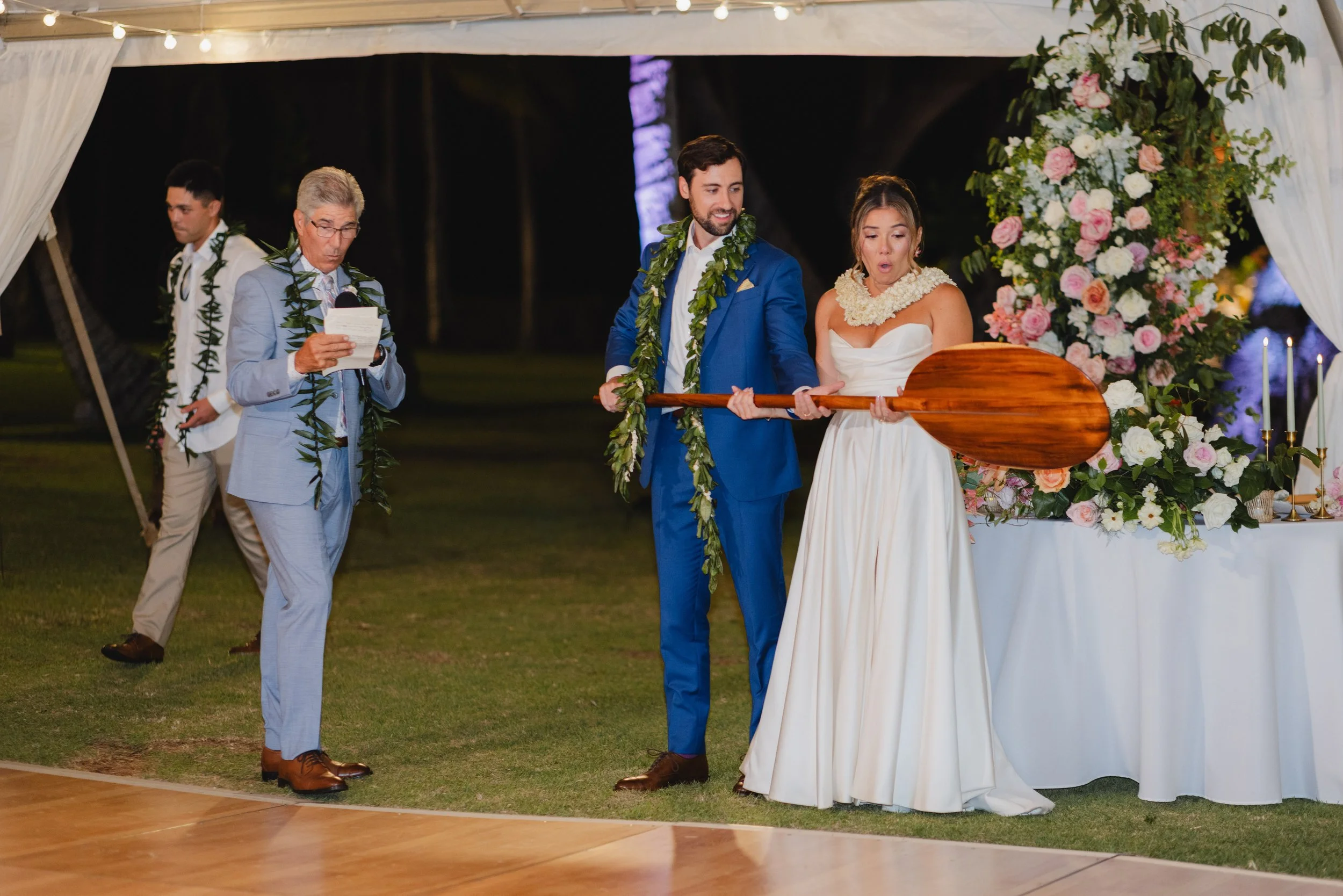 father gifting bride and groom canoe paddle