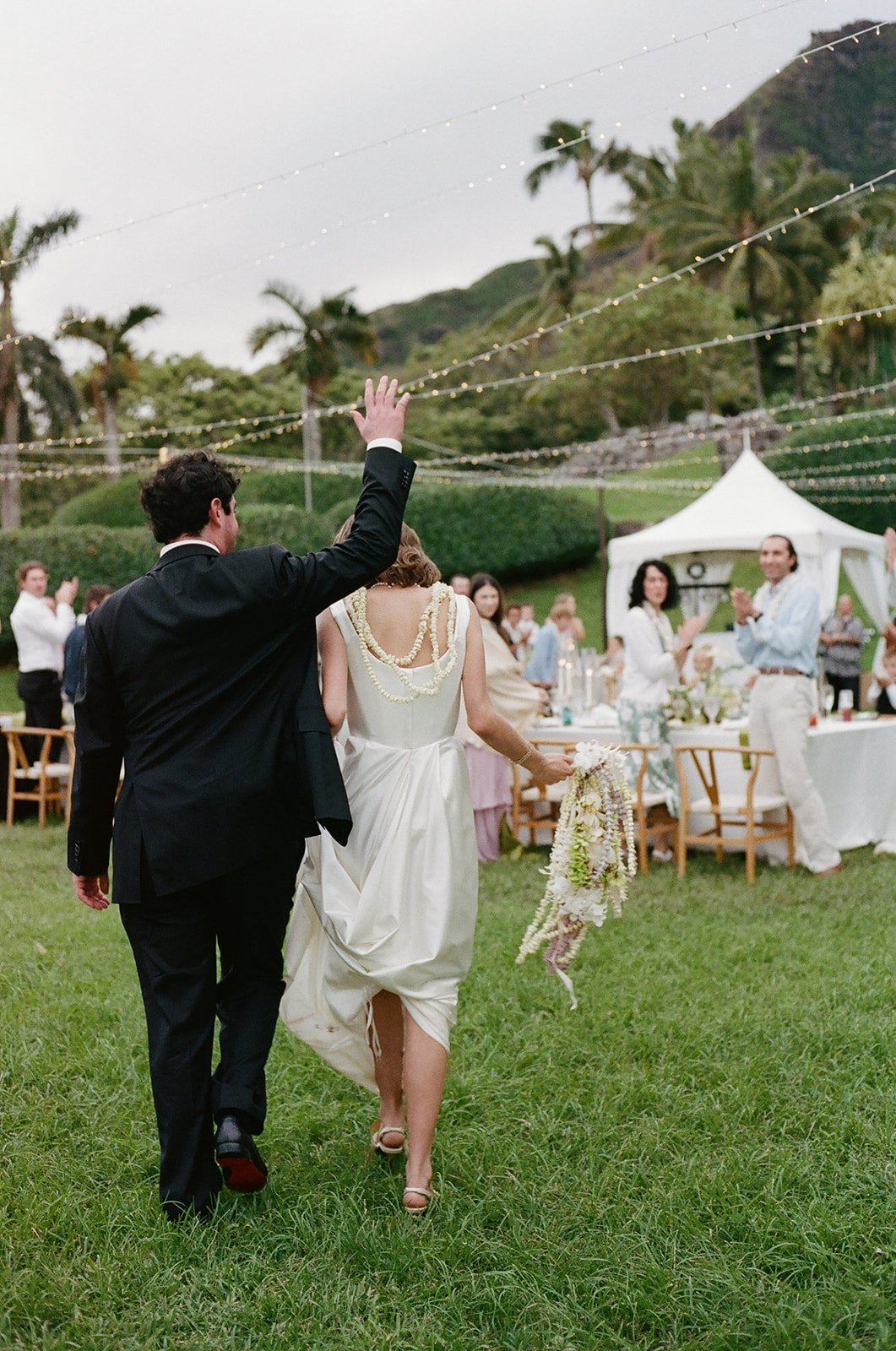 Bride and groom's grand entrance into their reception, styled by Hawaii wedding planner Love Letter Weddings at Paliku Gardens