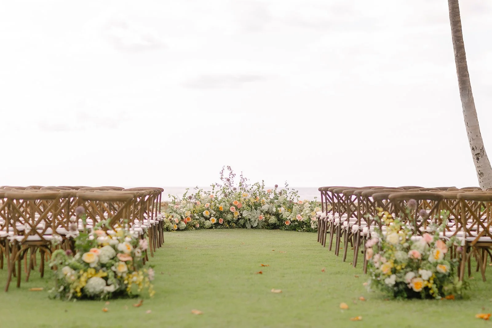 ceremony with floral altar by the ocean