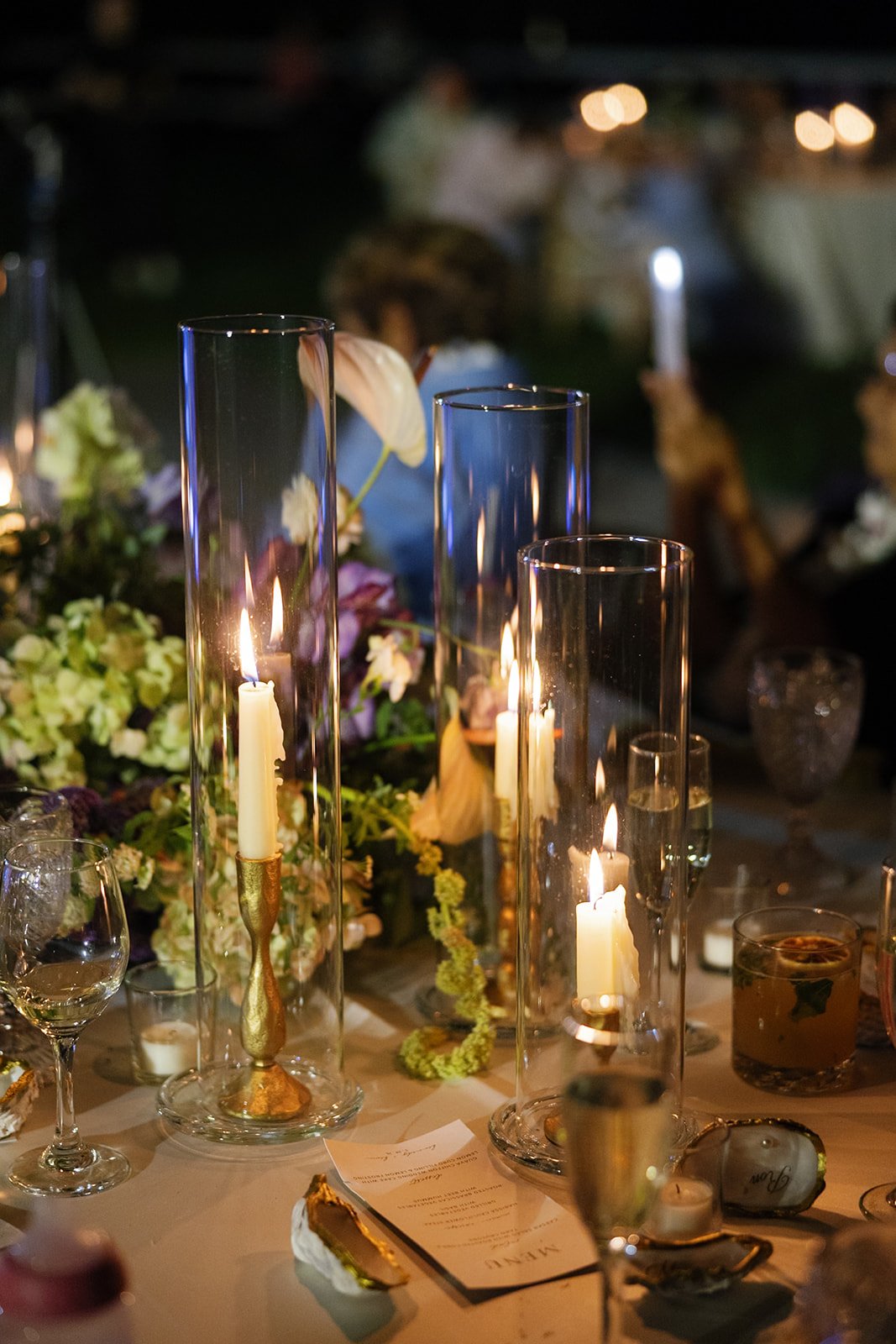 Evening tablescape with melting taper candles and cocktails, styled by Oahu wedding planner Love Letter Weddings at Paliku Gardens