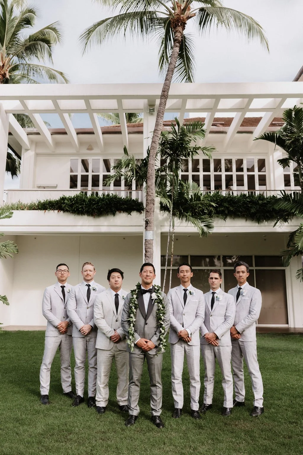 Groom and groomsmen pose for a portrait in Hawaii.
